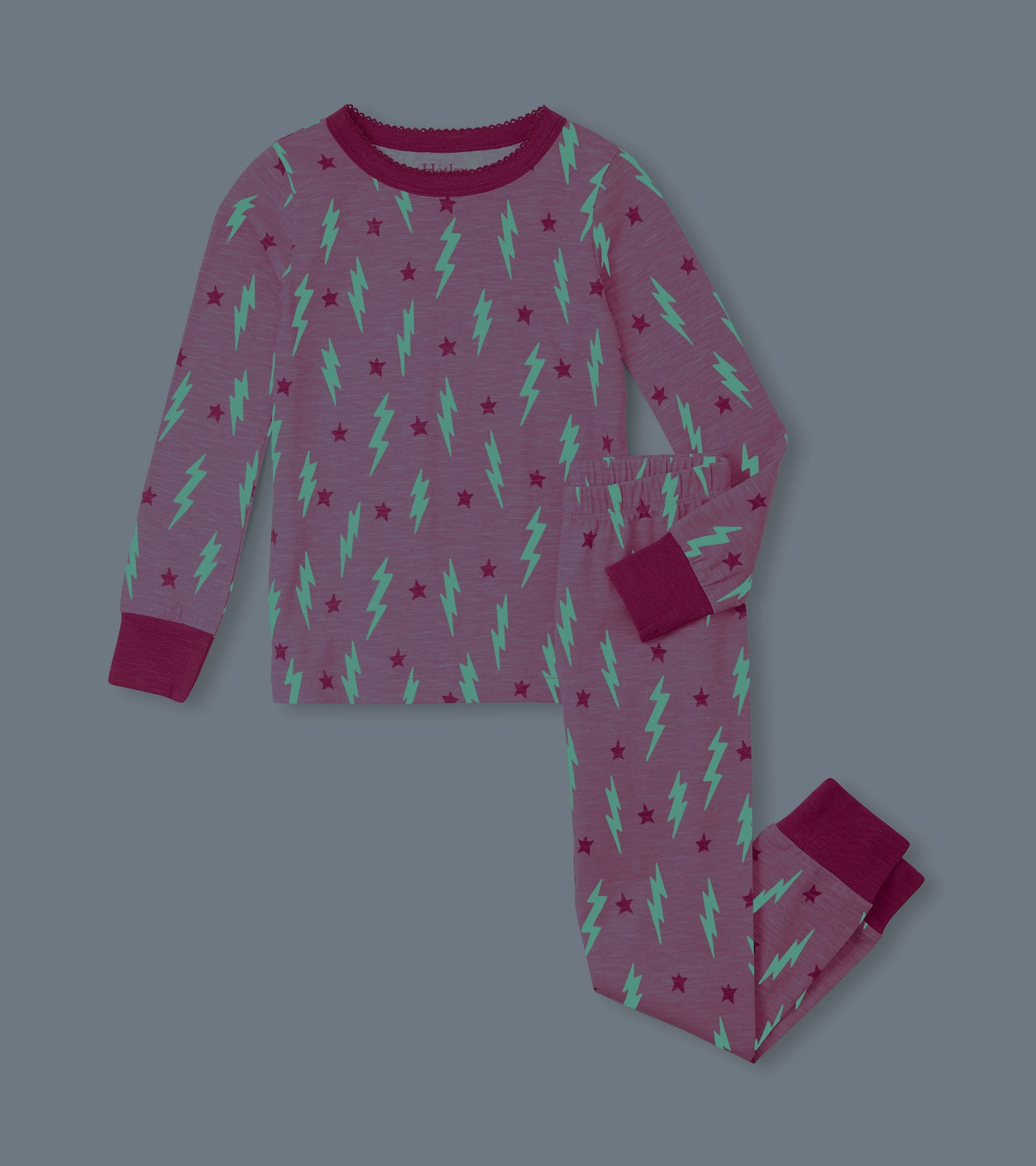Purple pajama set featuring green lightning bolts and red stars, with long sleeves and elastic waistband.
