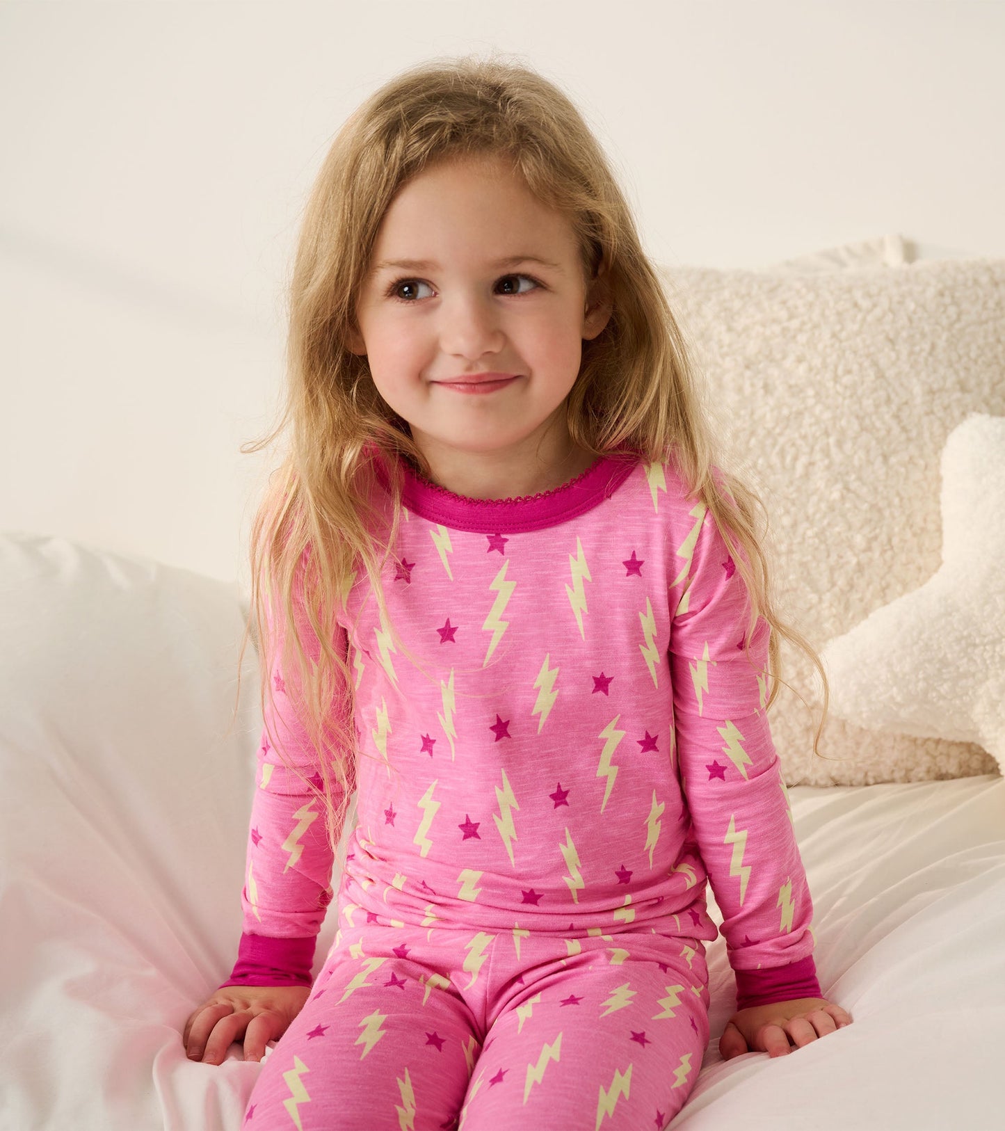 Pink pajama set featuring lightning bolts and stars, with long sleeves and a comfortable fit for girls.