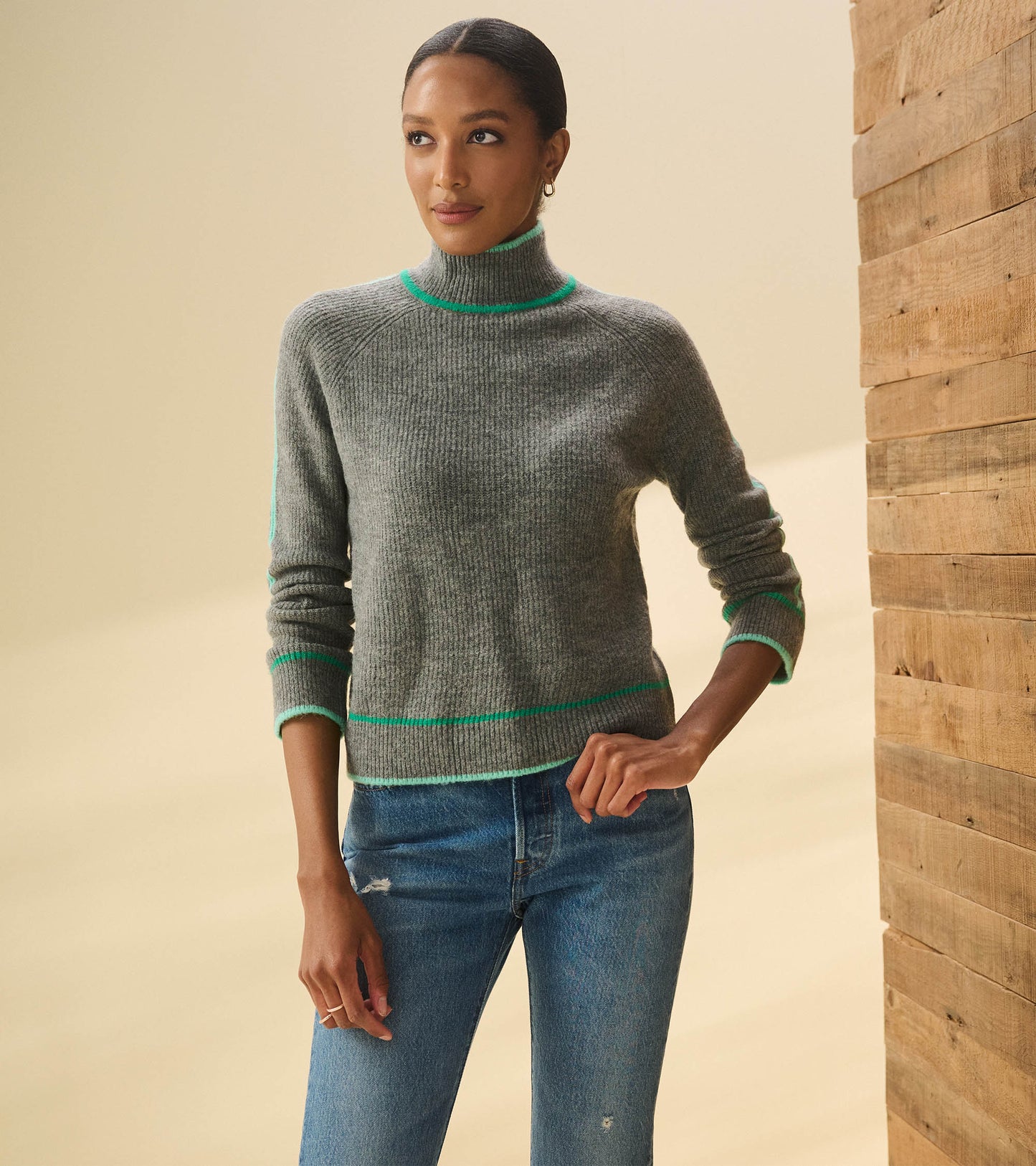 Charcoal heather pullover with a mock neck and green trim, featuring a fitted silhouette and ribbed texture.