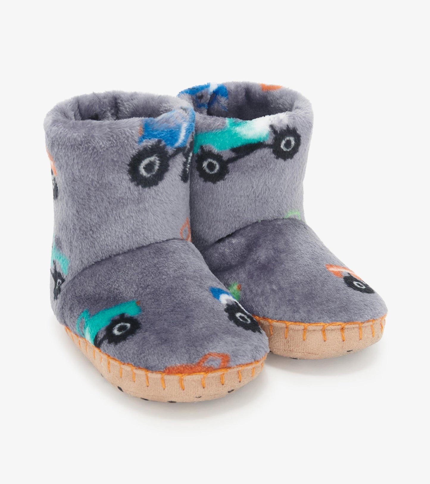 Gray fleece slippers featuring colorful monster truck patterns and a soft, cozy design for baby boys.