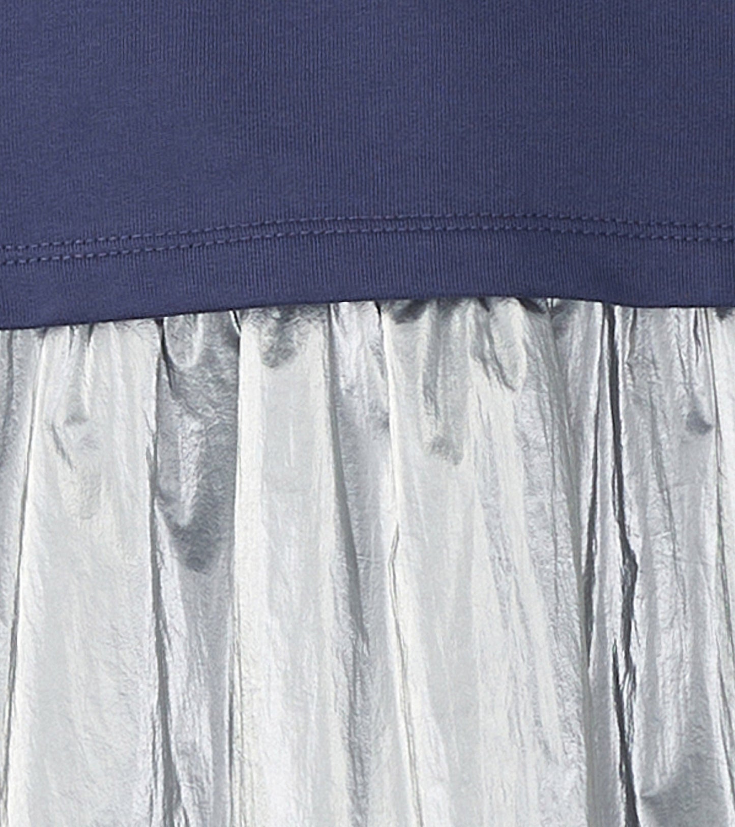 Navy top with a dropped waist, featuring a shiny silver pleated skirt.