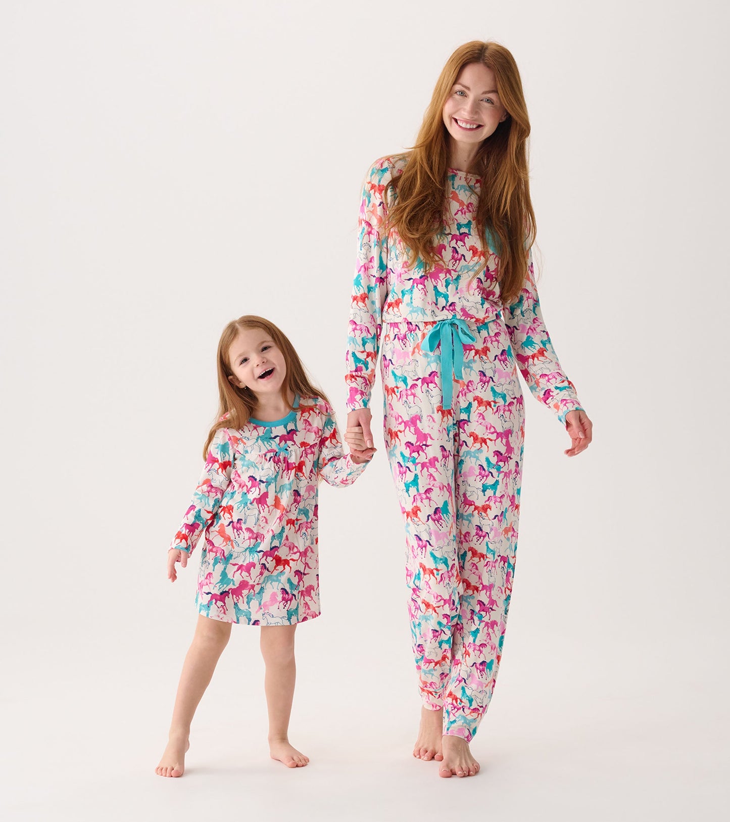 Colorful nightgown featuring a playful horse pattern, with long sleeves and a relaxed fit, worn by a girl and her mother.