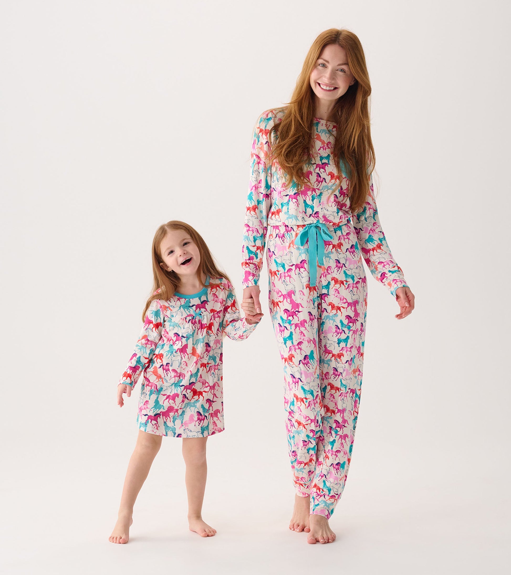 Colorful nightgown featuring a playful horse pattern, with long sleeves and a relaxed fit, worn by a girl and her mother.