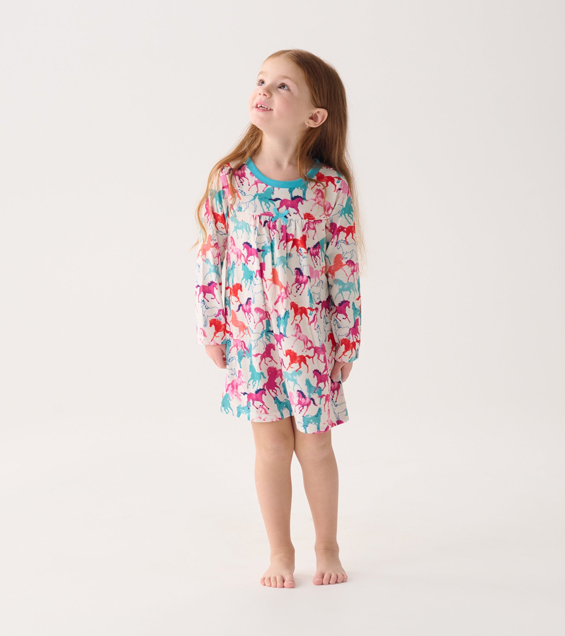 Colorful long-sleeve nightgown featuring a playful horse pattern, perfect for girls.