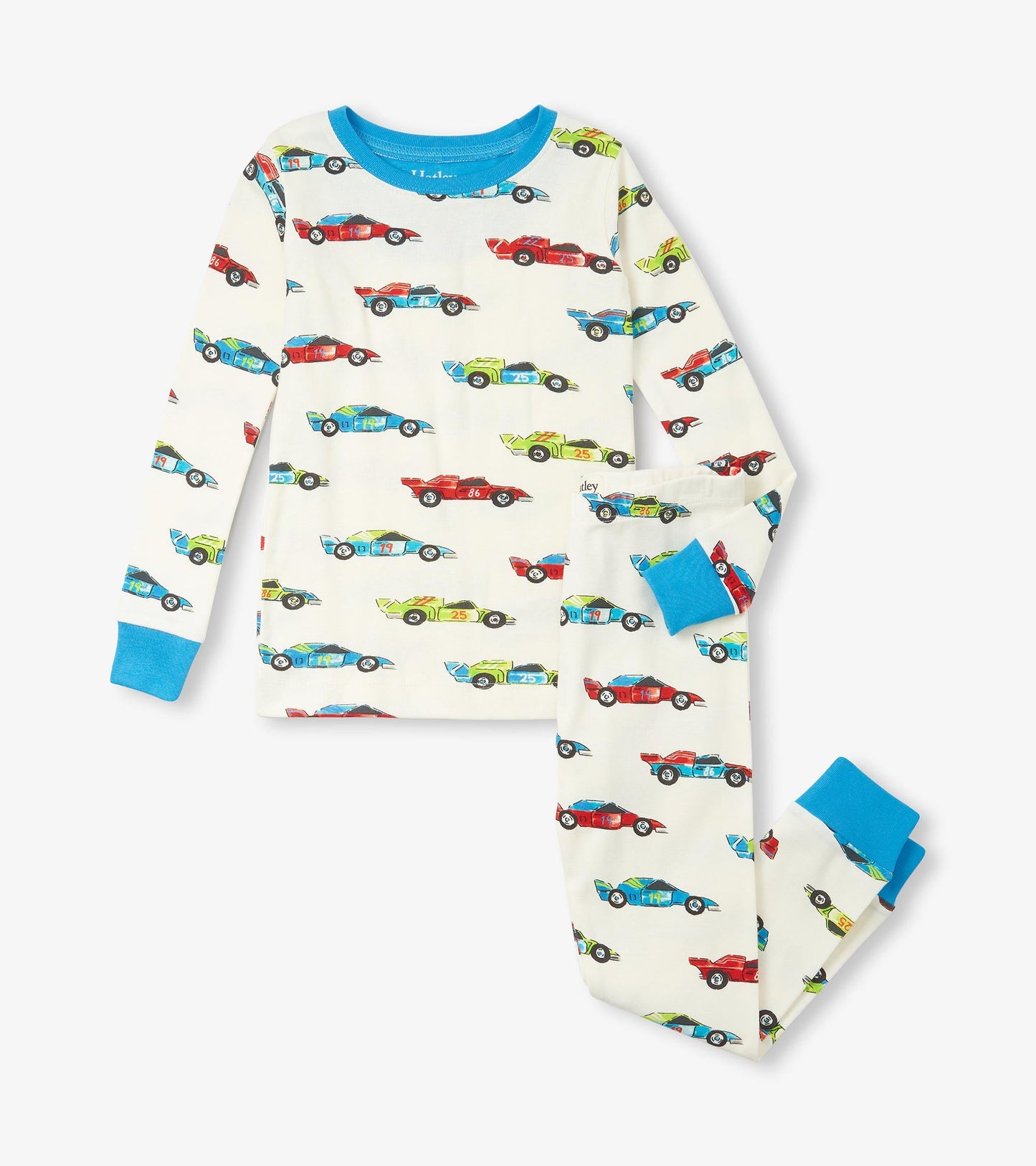 Organic cotton pajama set featuring colorful racecar prints on a cream background with blue cuffs and neckline.