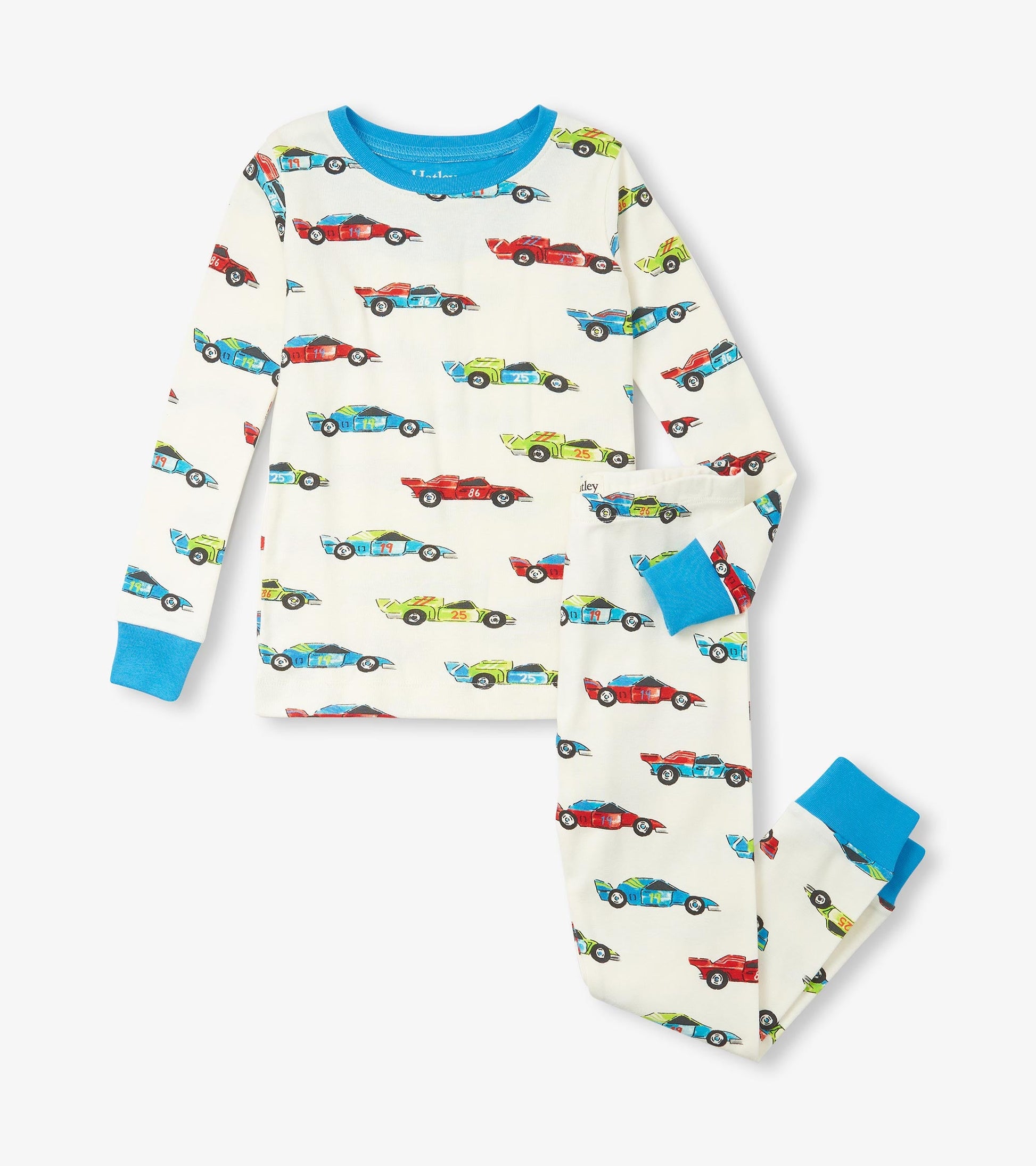 Organic cotton pajama set featuring colorful racecar prints on a cream background with blue cuffs and neckline.
