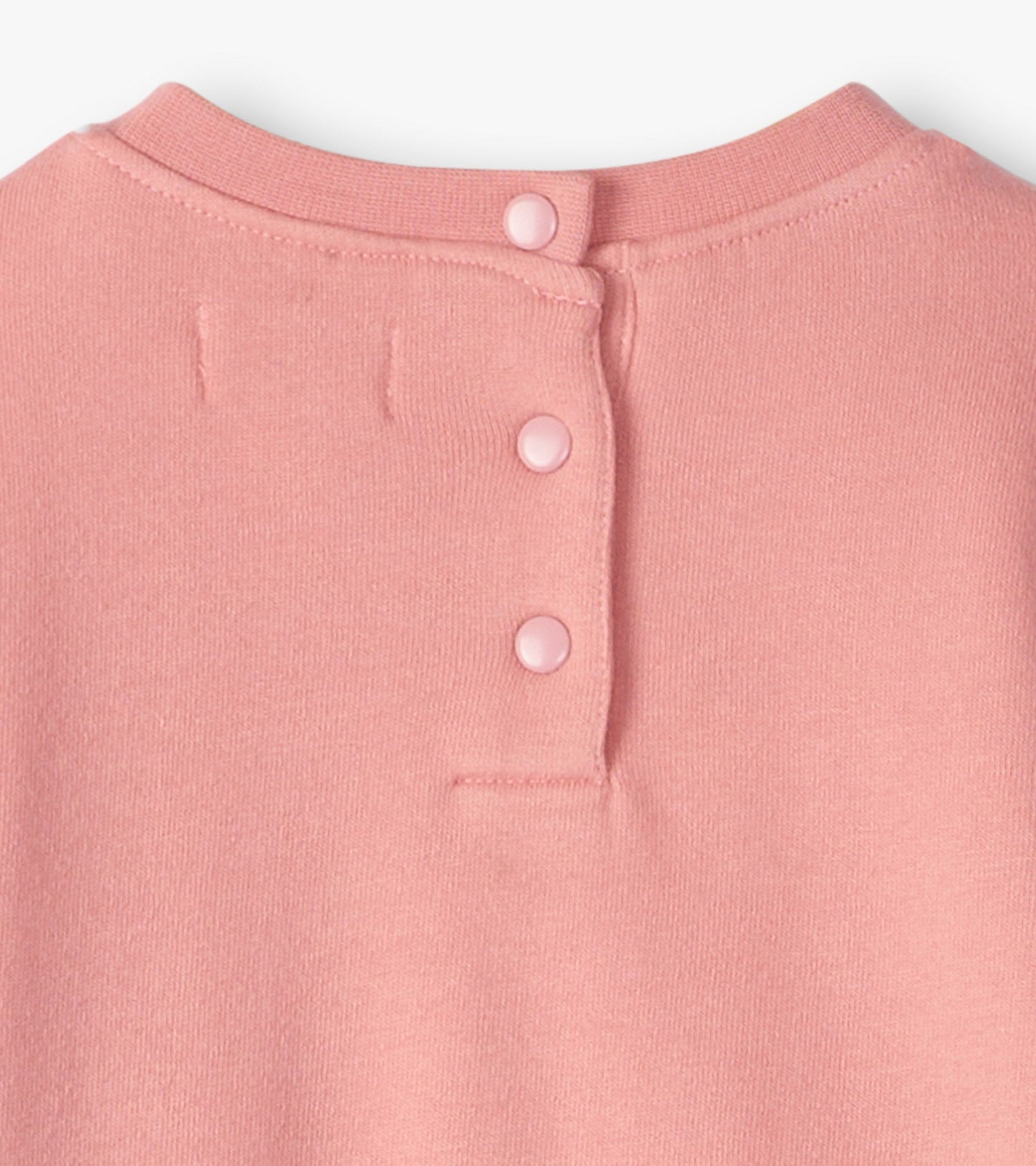 Light pink cozy dress with a round neckline and three button closure at the back. Soft fabric suitable for baby and toddler…
