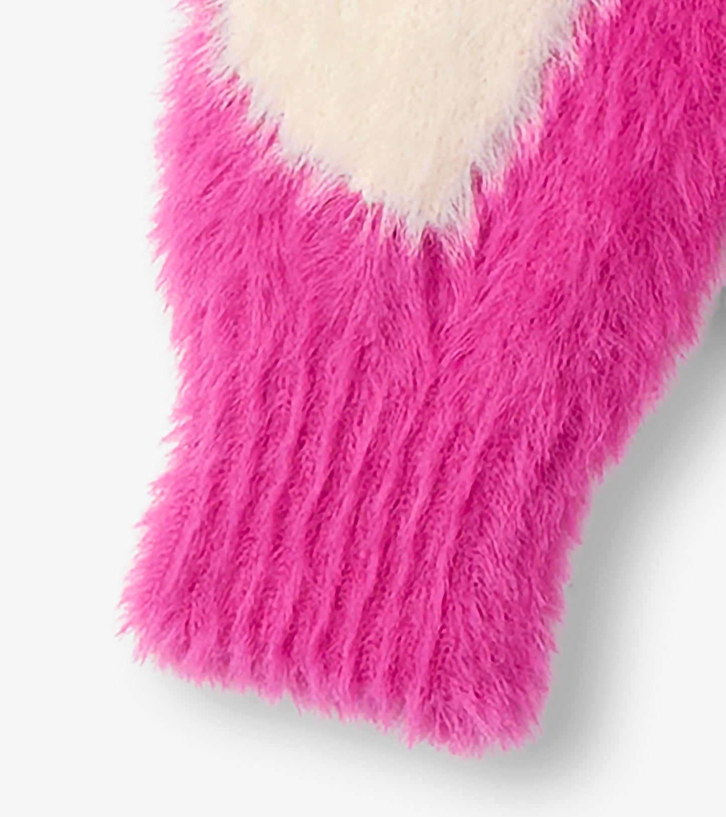 Fuzzy pink cardigan featuring a large white heart pattern, perfect for layering in cooler weather.