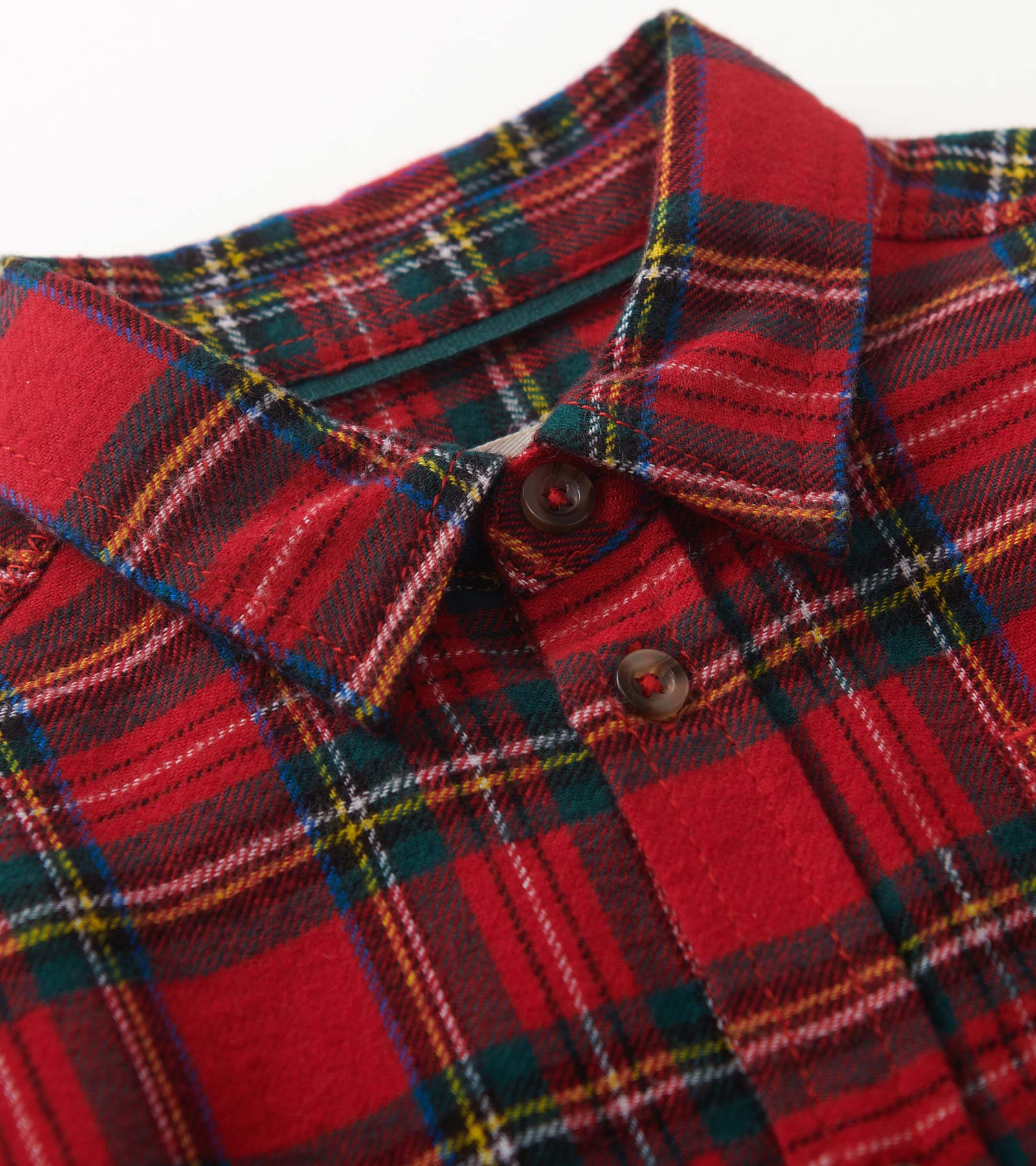Red plaid button-down shirt with a collar and button closure, featuring green, yellow, and white accents.