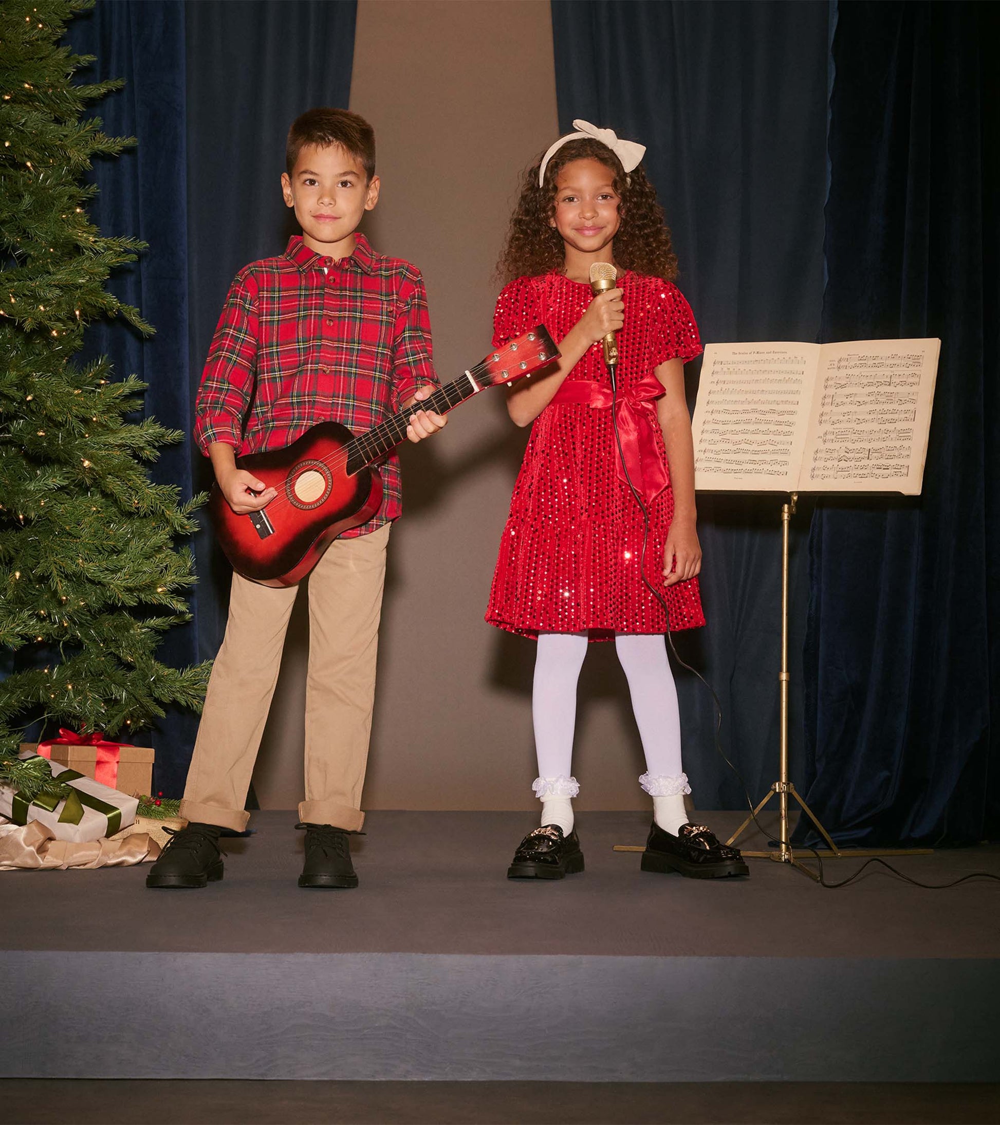 Red plaid button-down shirt for boys, featuring long sleeves and a classic collar, styled for festive occasions.