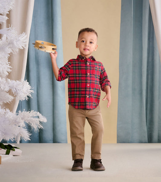 Red plaid button-down shirt for babies and toddlers, featuring a classic collar and button closure, worn with beige pants.