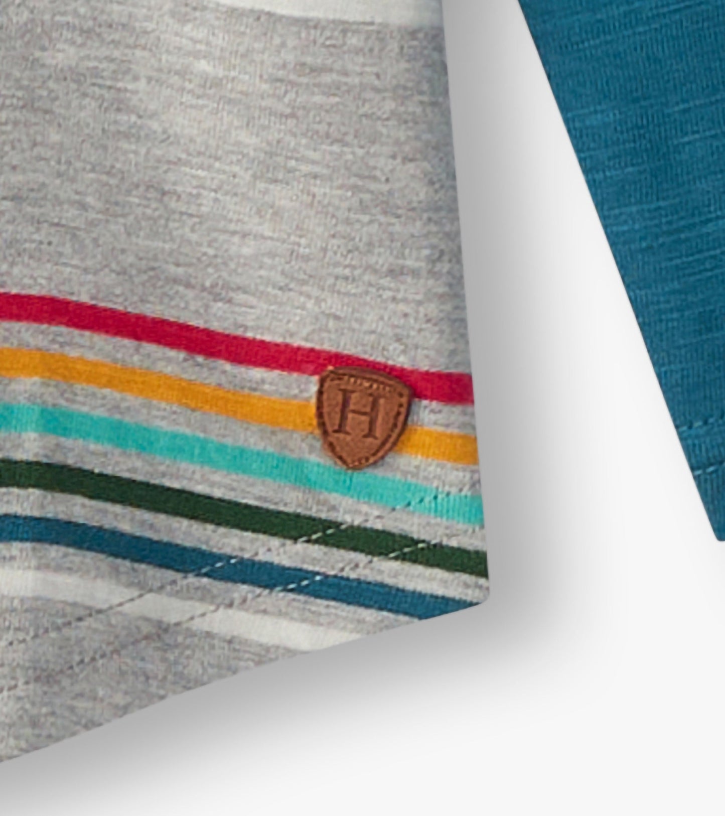 Gray long sleeve raglan t-shirt featuring colorful retro stripes and a brown logo patch on the hem.