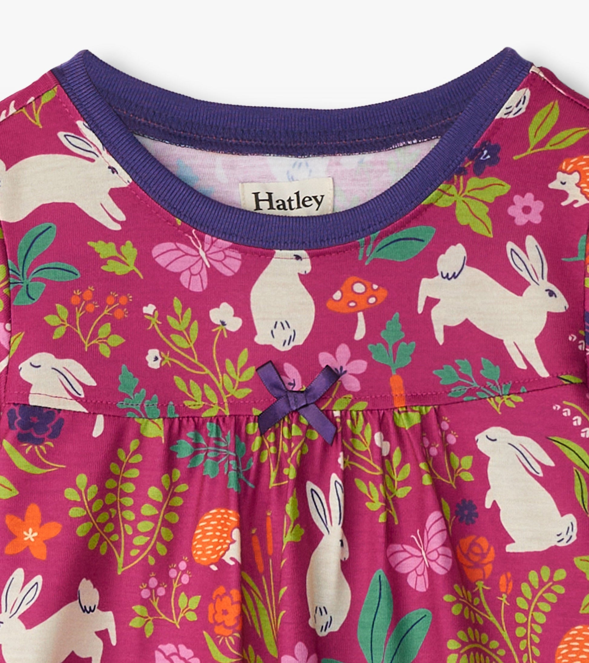 Purple nightgown featuring a playful bunny and floral pattern, with a gathered waist and a decorative bow.