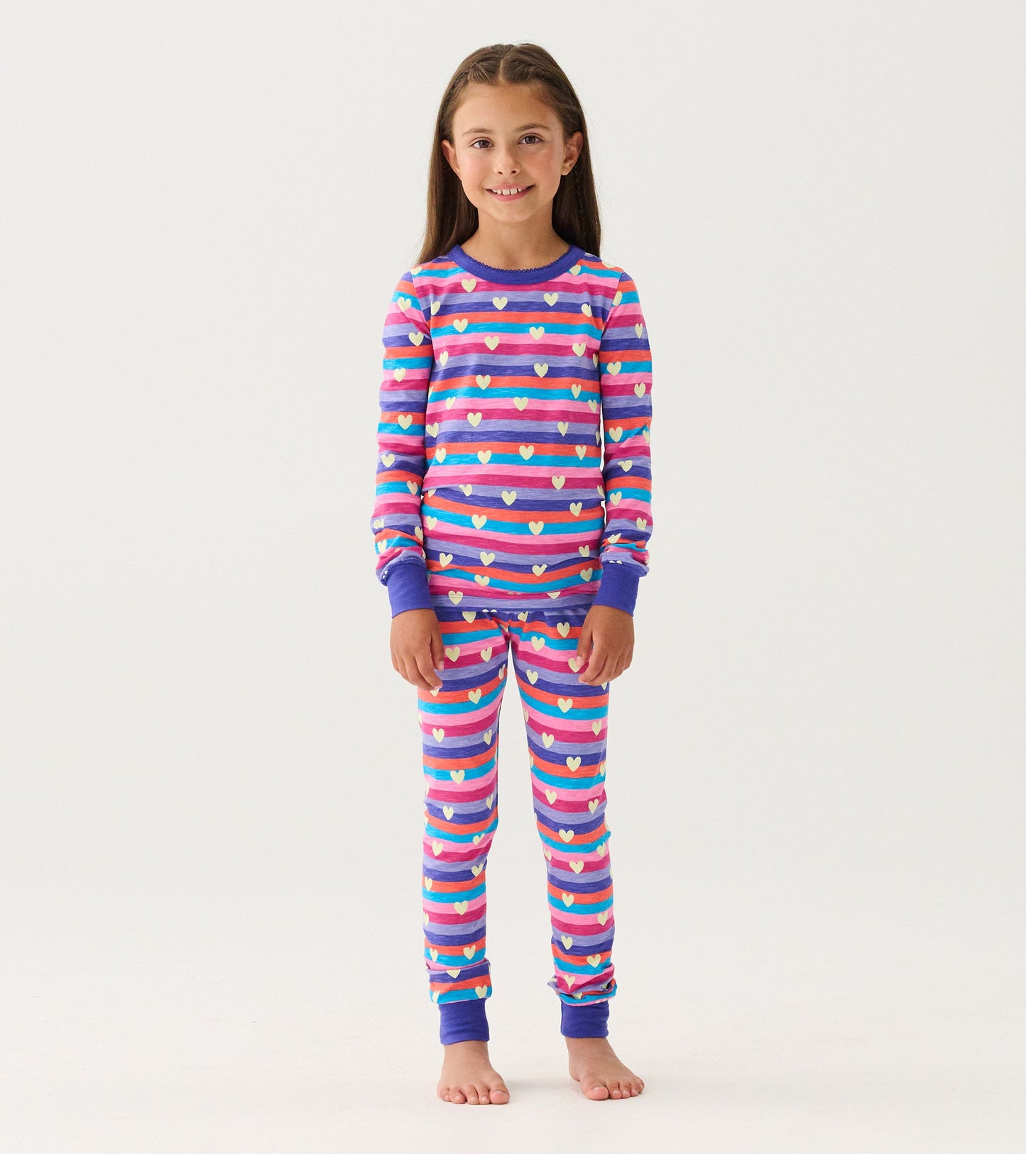 Purple striped pajama set featuring colorful hearts, long sleeves, and elastic cuffs, suitable for girls.