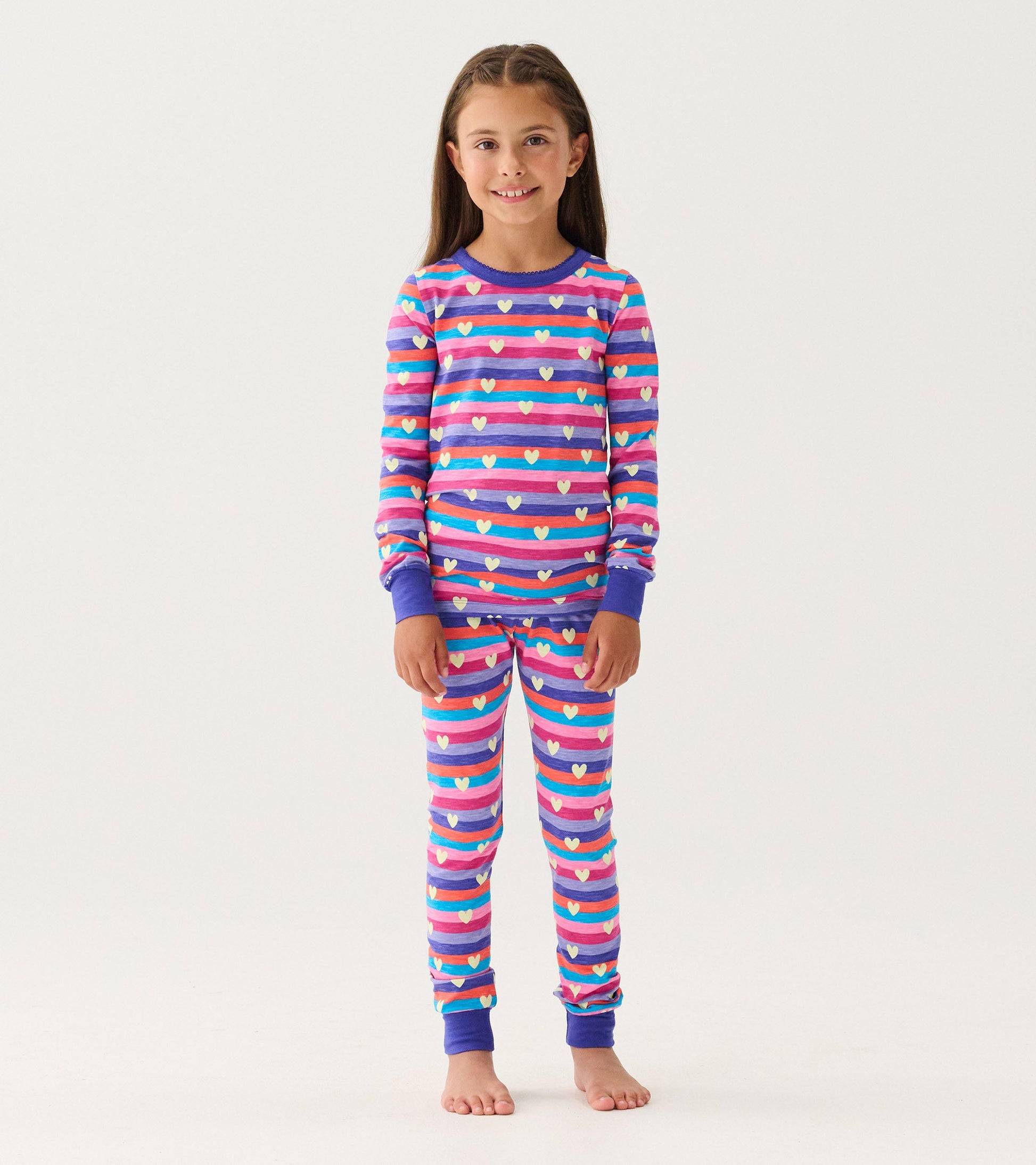Purple striped pajama set featuring colorful hearts, long sleeves, and elastic cuffs, suitable for girls.