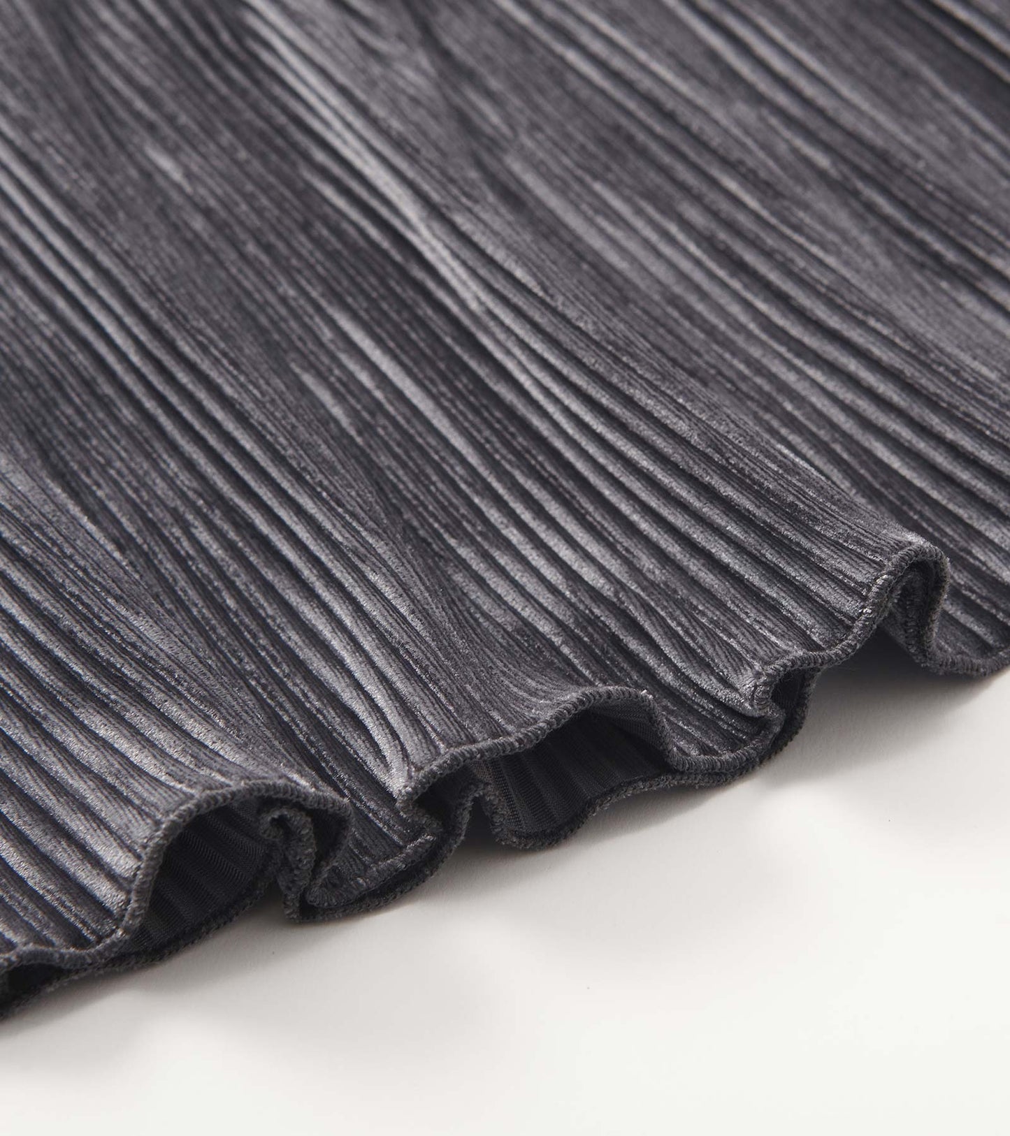 Silver pleated velour skirt with a soft texture and ruffled hem, suitable for girls.
