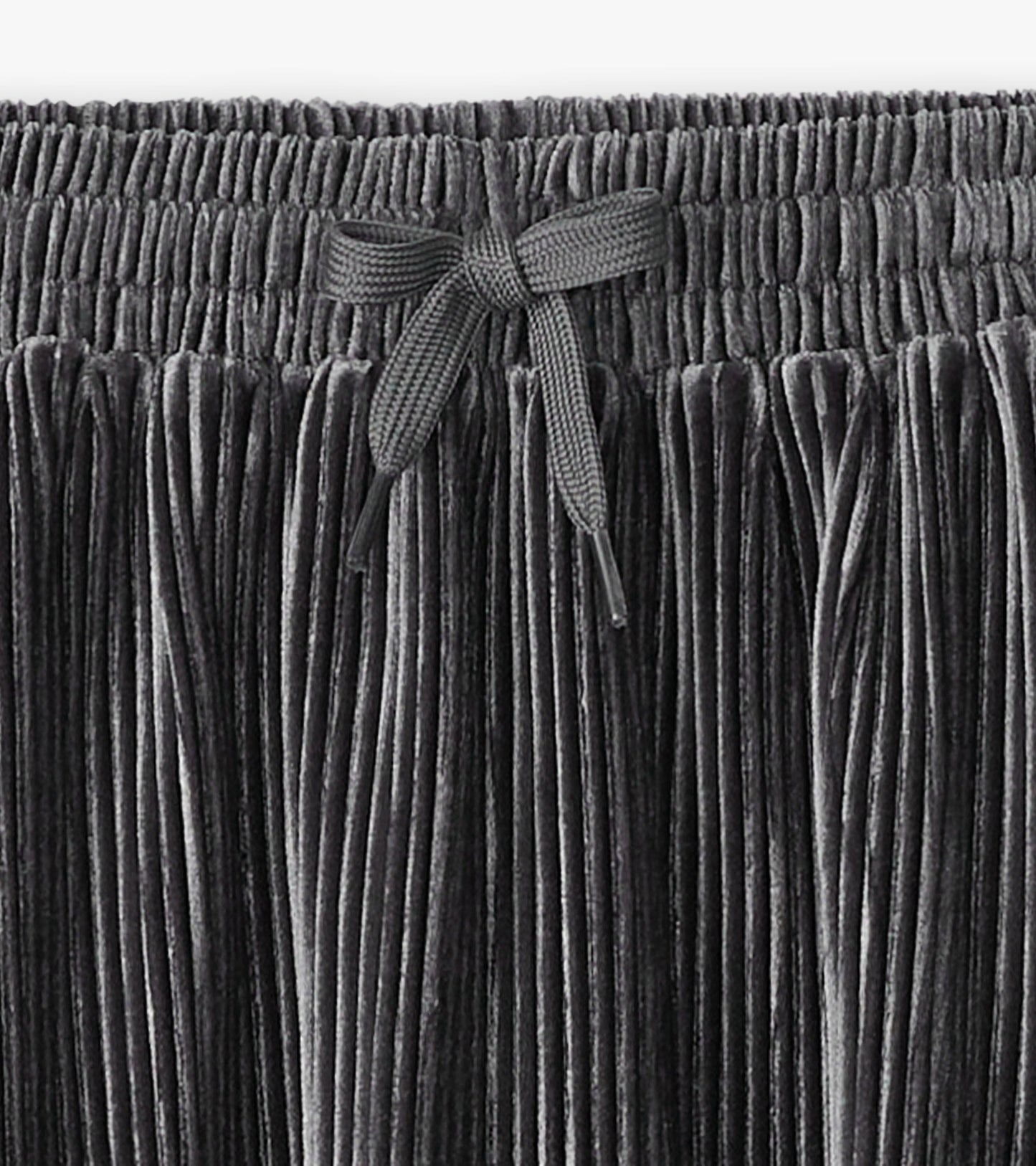 Silver pleated velour skirt with an elastic waistband and bow detail, suitable for girls.