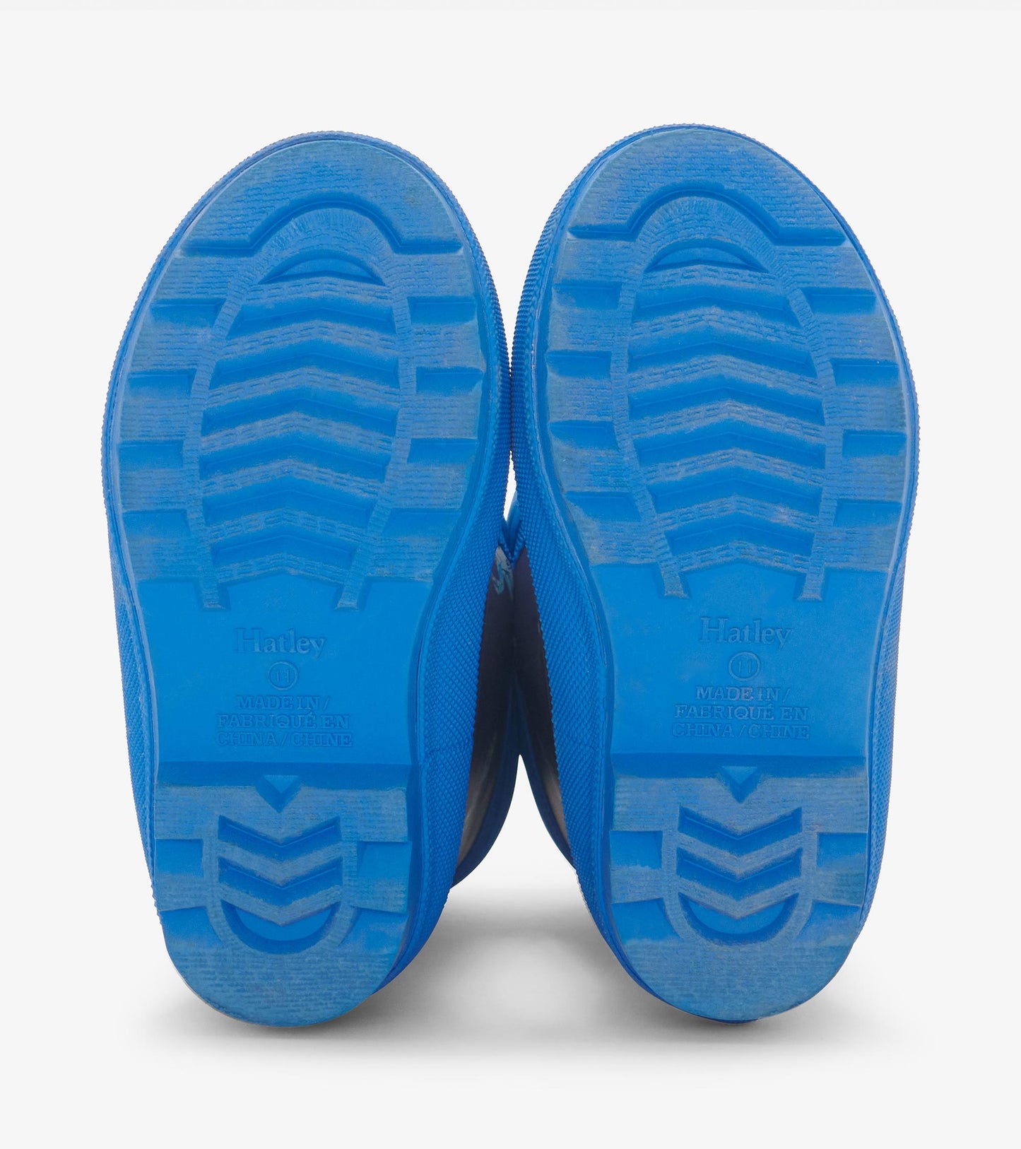 Blue rain boots with a textured sole, designed for kids, featuring a sherpa lining for warmth.