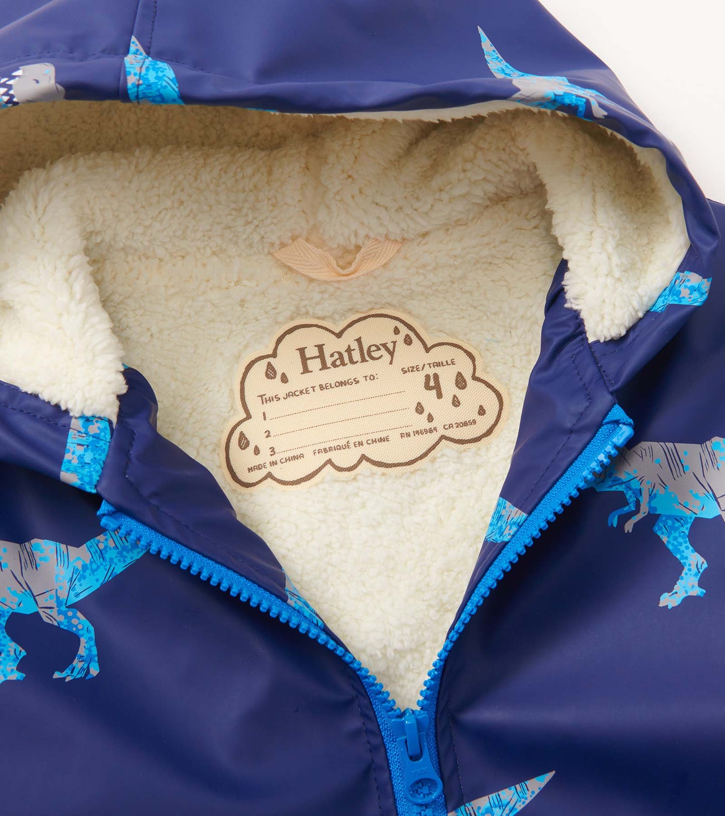 Navy zip-up rain jacket with T-Rex print and soft sherpa lining, featuring a bright blue zipper and tag for size 4.
