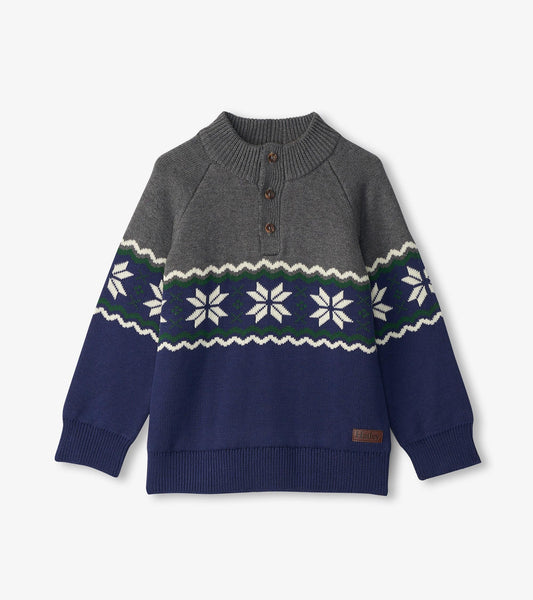 Gray and navy knit mockneck sweater featuring a snowflake pattern and three buttons at the collar.