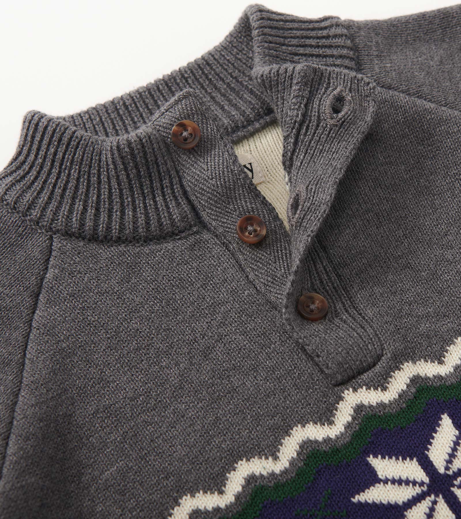 Gray knit mockneck sweater featuring a button placket and a colorful patterned design along the bottom.