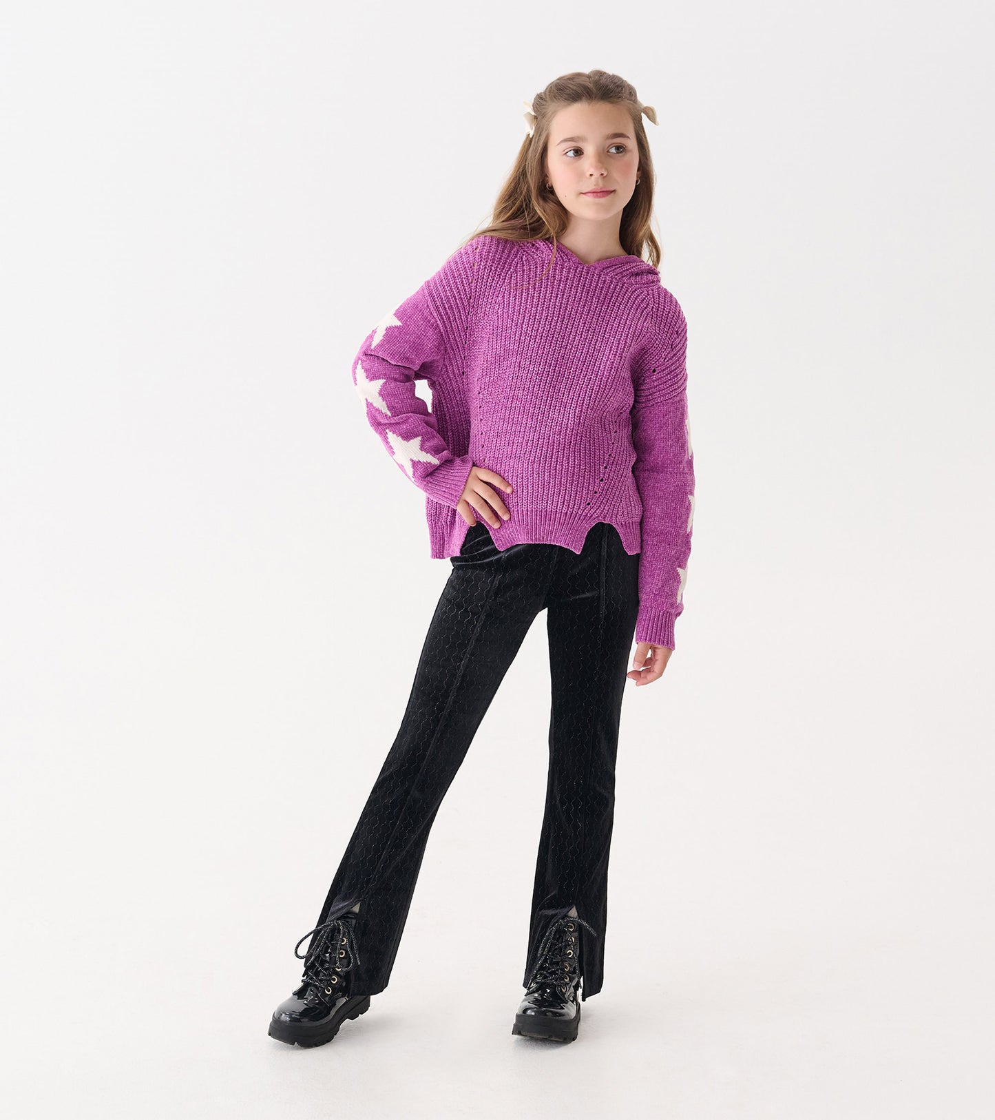 Black velour flared pants with a subtle sparkle, featuring a textured wave pattern, suitable for casual wear.