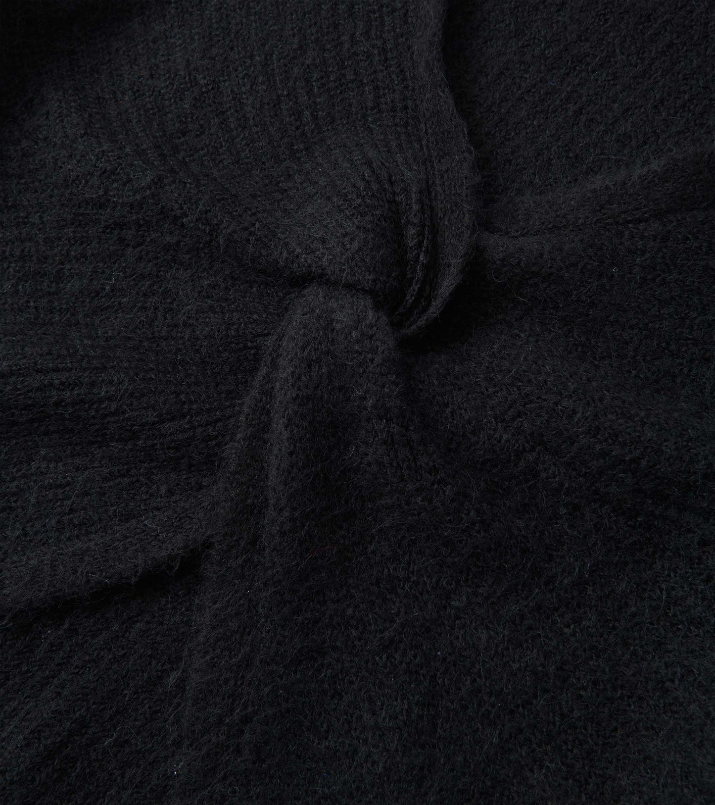 Black cross over sweater made of soft, textured fabric, showcasing a cozy and relaxed design.