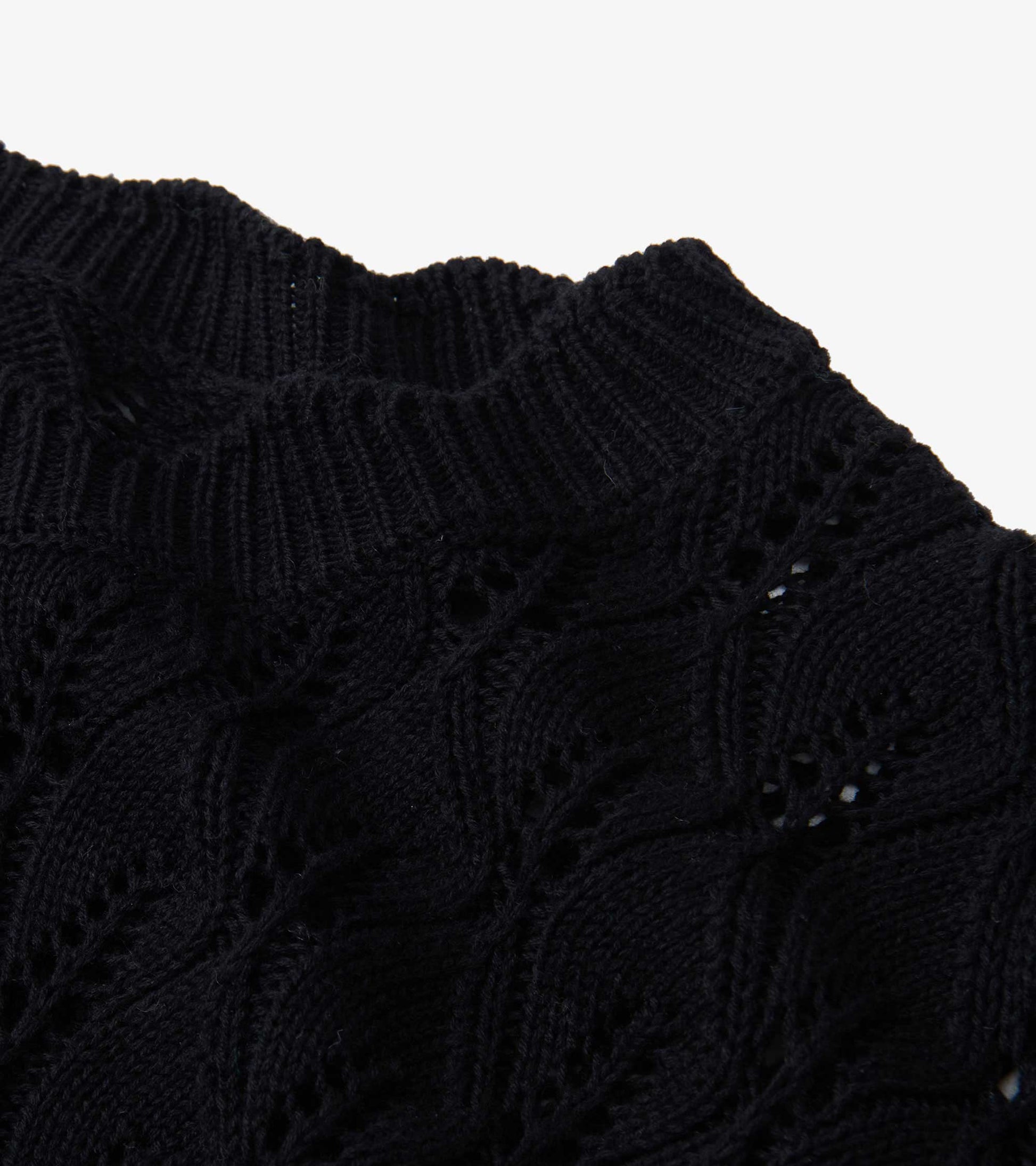 Black knitted sweater featuring a textured leaf pattern and a ribbed neckline.