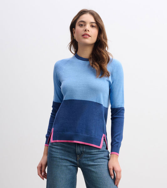 Blue color block sweater featuring a round neckline and contrasting pink trim at the hem and cuffs.