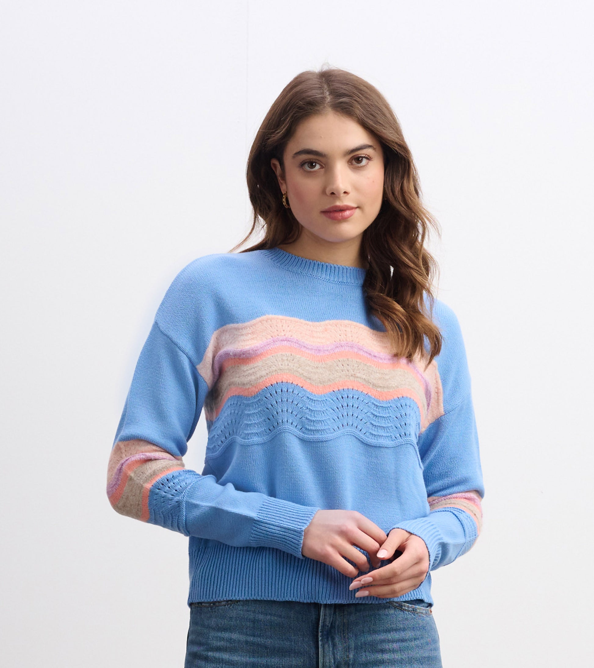 Sky blue sweater featuring a wave pattern in pink and beige, with a relaxed fit and ribbed cuffs.