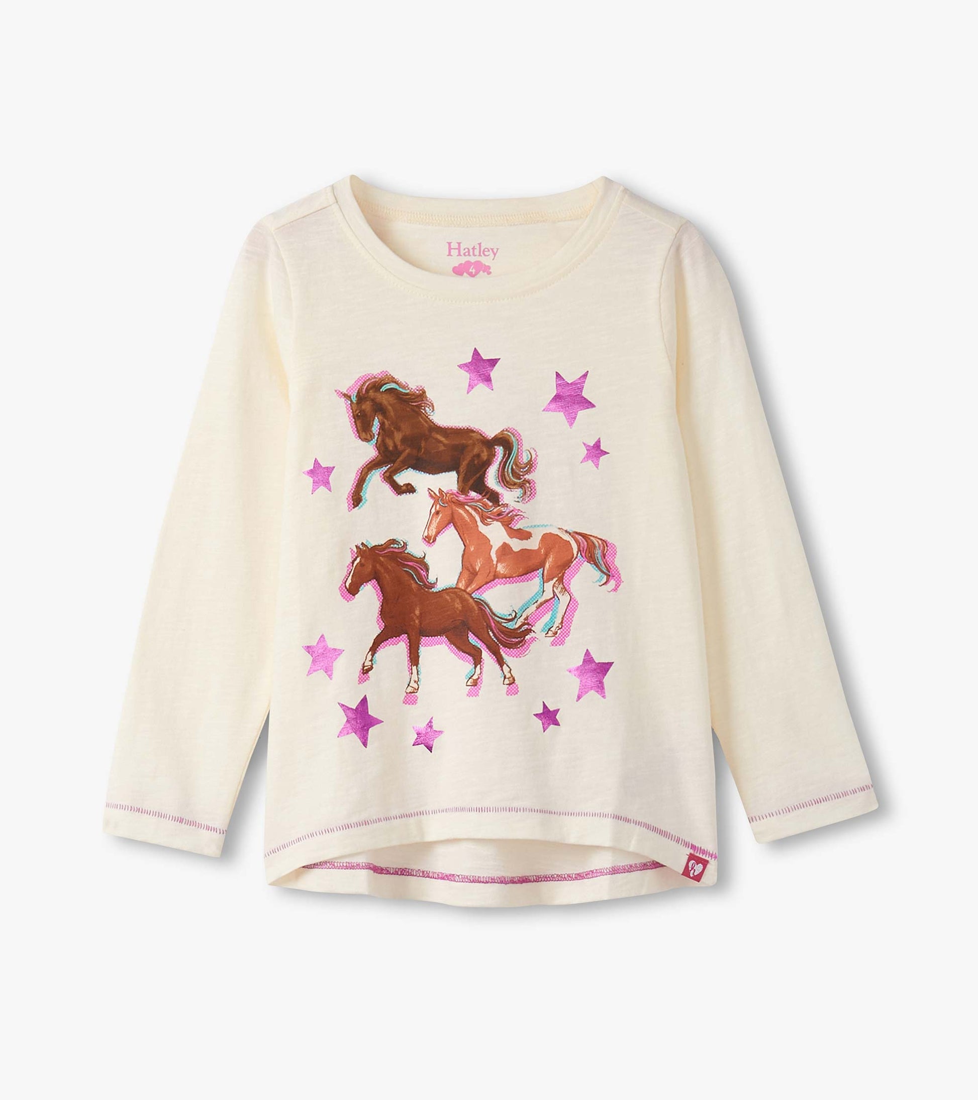 Cream long sleeve tee featuring colorful galloping horses and pink stars, perfect for casual wear.