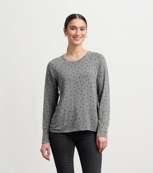 Gray long-sleeve pullover with black polka dots, featuring a relaxed fit and round neckline.