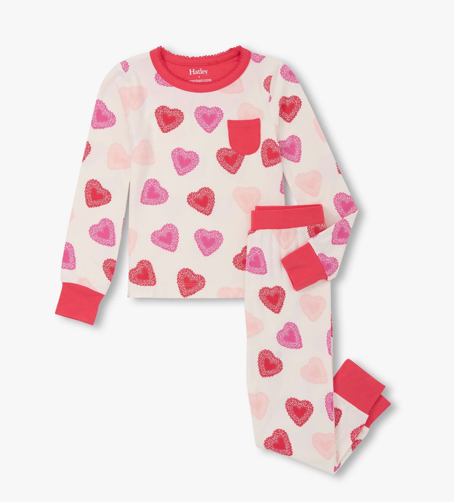 Long-sleeve pajama set featuring a cream background with colorful heart patterns in pink and red, with contrasting cuffs.