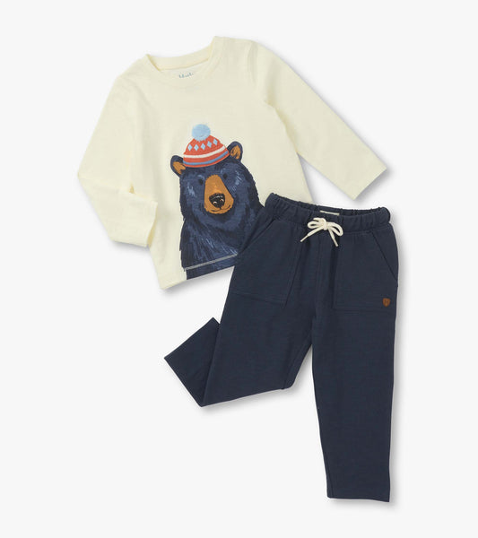 Cream long-sleeve shirt with bear graphic and navy lounge pants with pockets and drawstring. Suitable for baby and toddler b…