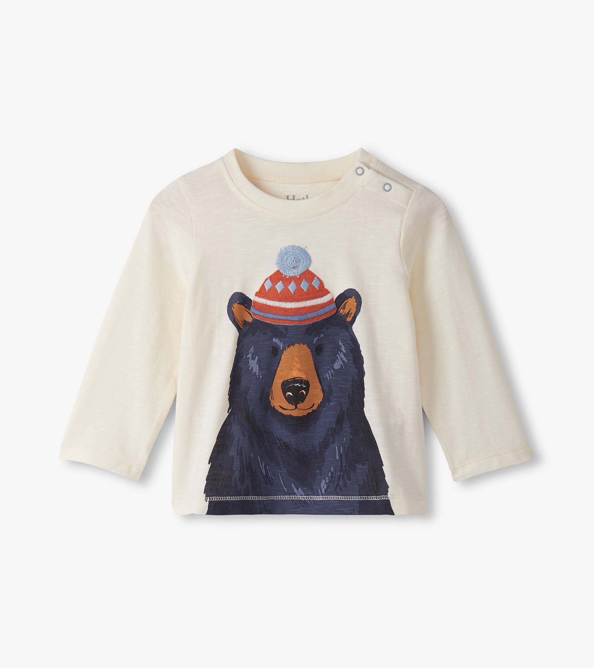 Cream long-sleeve top featuring a bear graphic wearing a red and blue hat, designed for baby and toddler boys.
