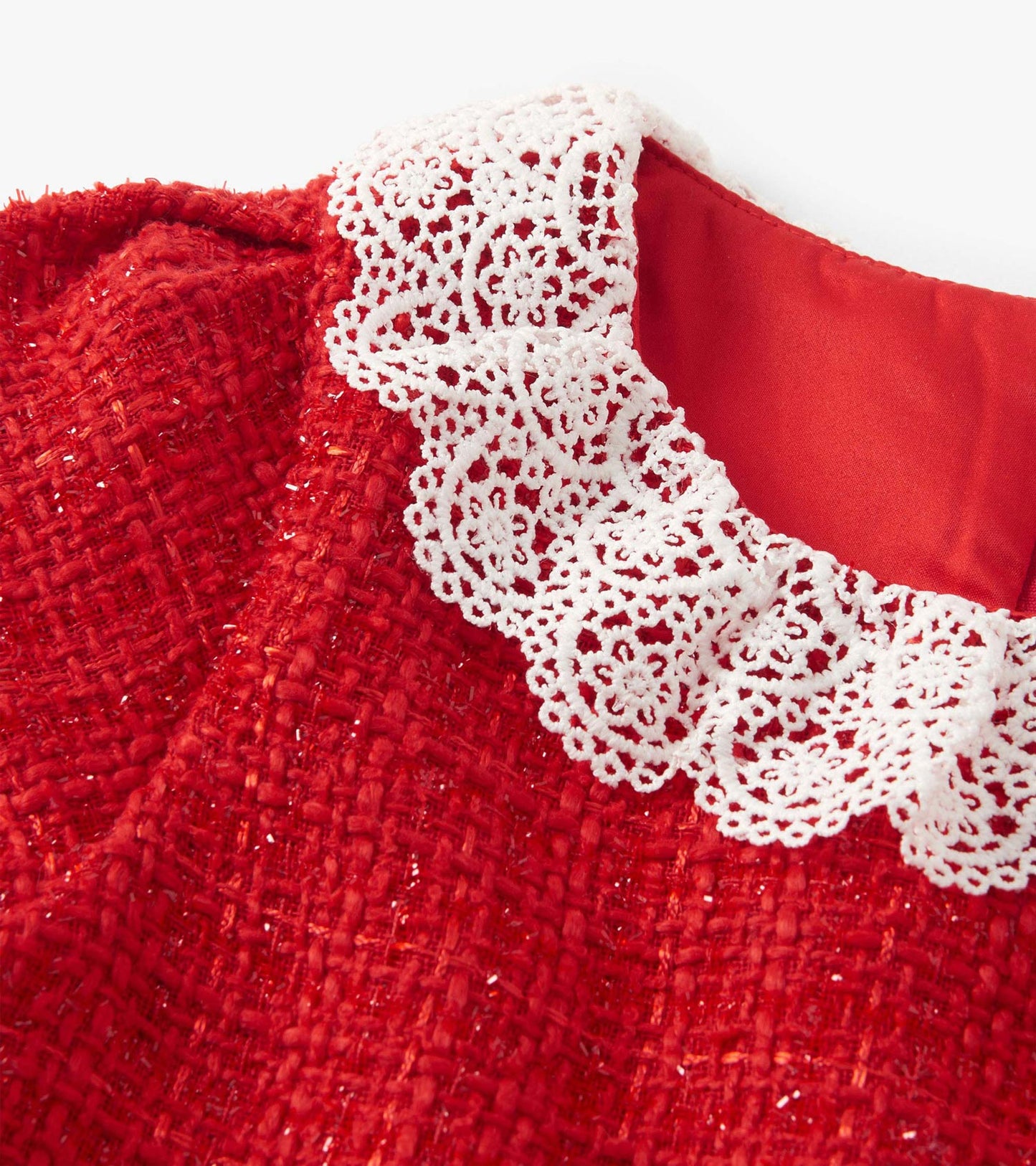 Red boucle dress featuring a pleated design and a white lace collar.