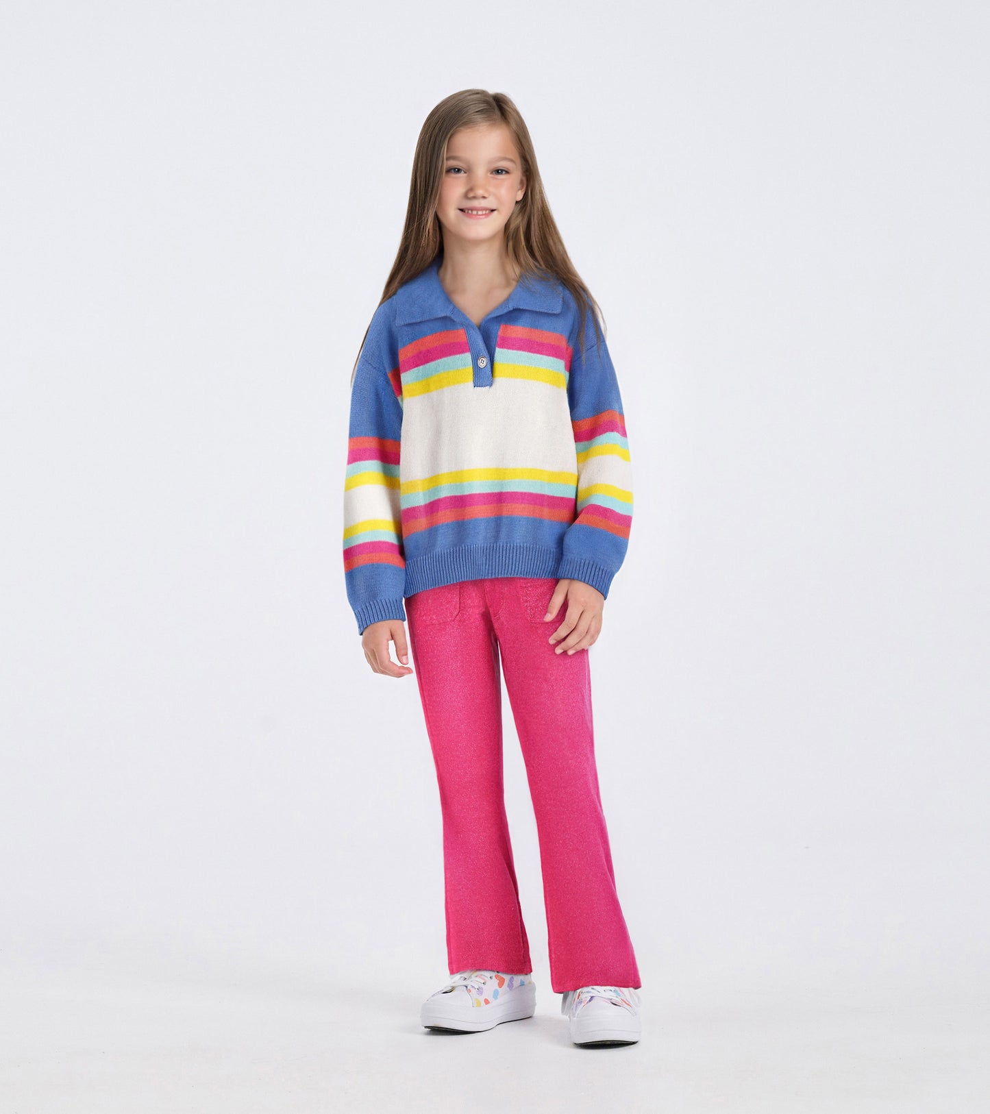 Colorblock sweater featuring blue, white, yellow, and pink stripes, paired with pink pants and white shoes.