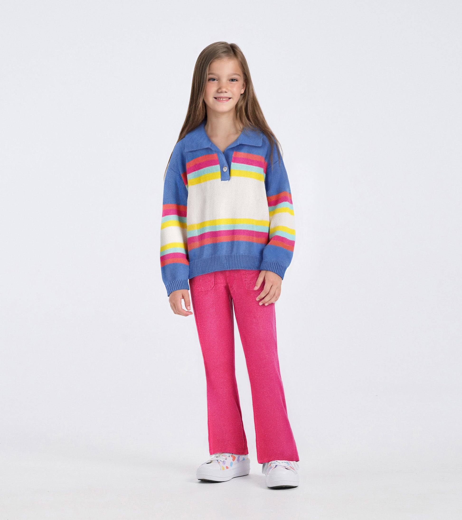Colorblock sweater featuring blue, white, yellow, and pink stripes, paired with pink pants and white shoes.