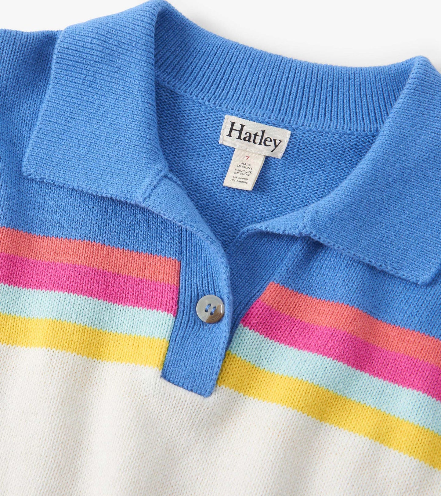 Colorblock sweater featuring a blue collar, vibrant stripes in pink, orange, yellow, and light blue on a cream base.