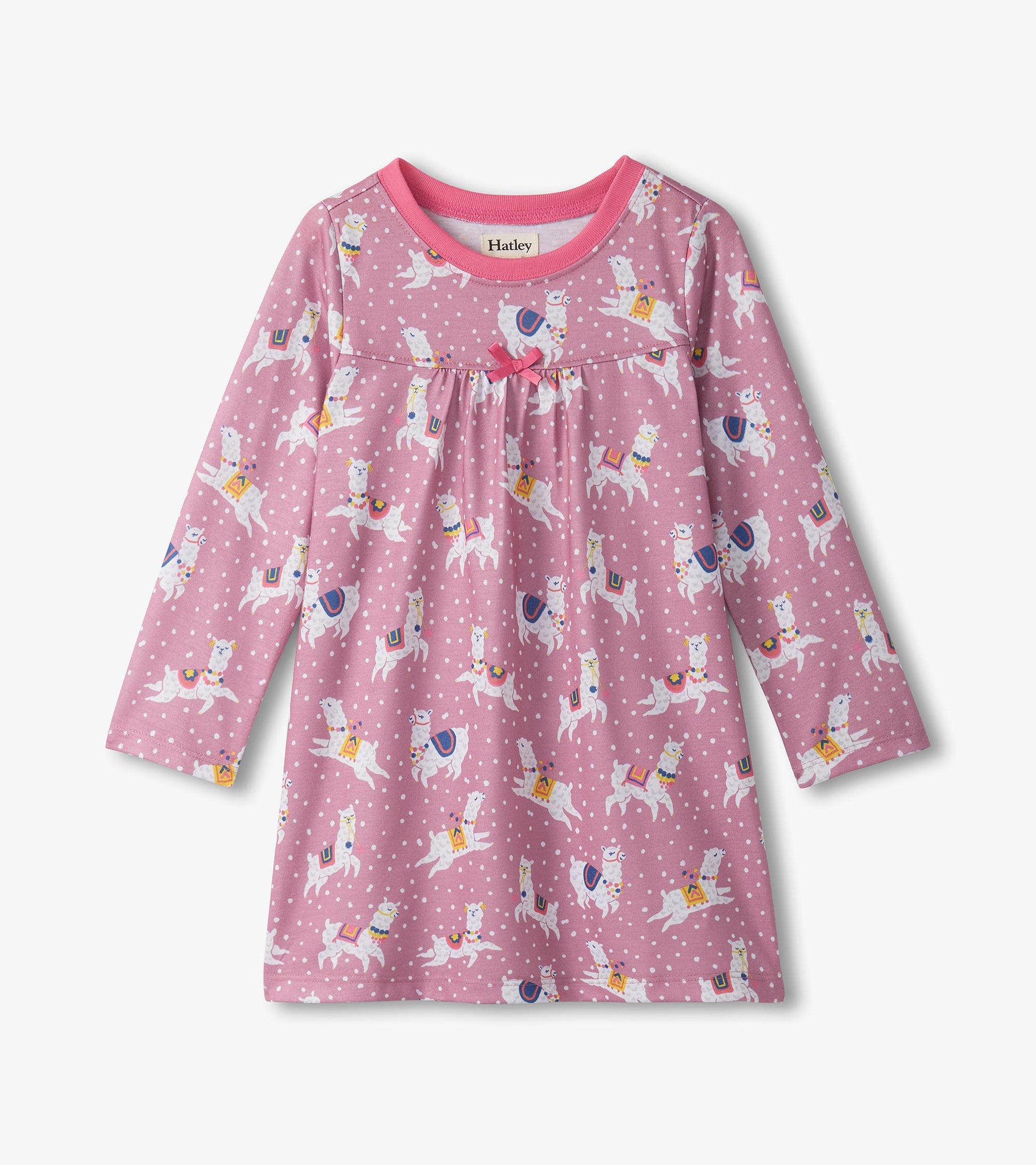 Pink long sleeve nightdress featuring dancing alpacas and polka dots, with a gathered bodice and a round neckline.