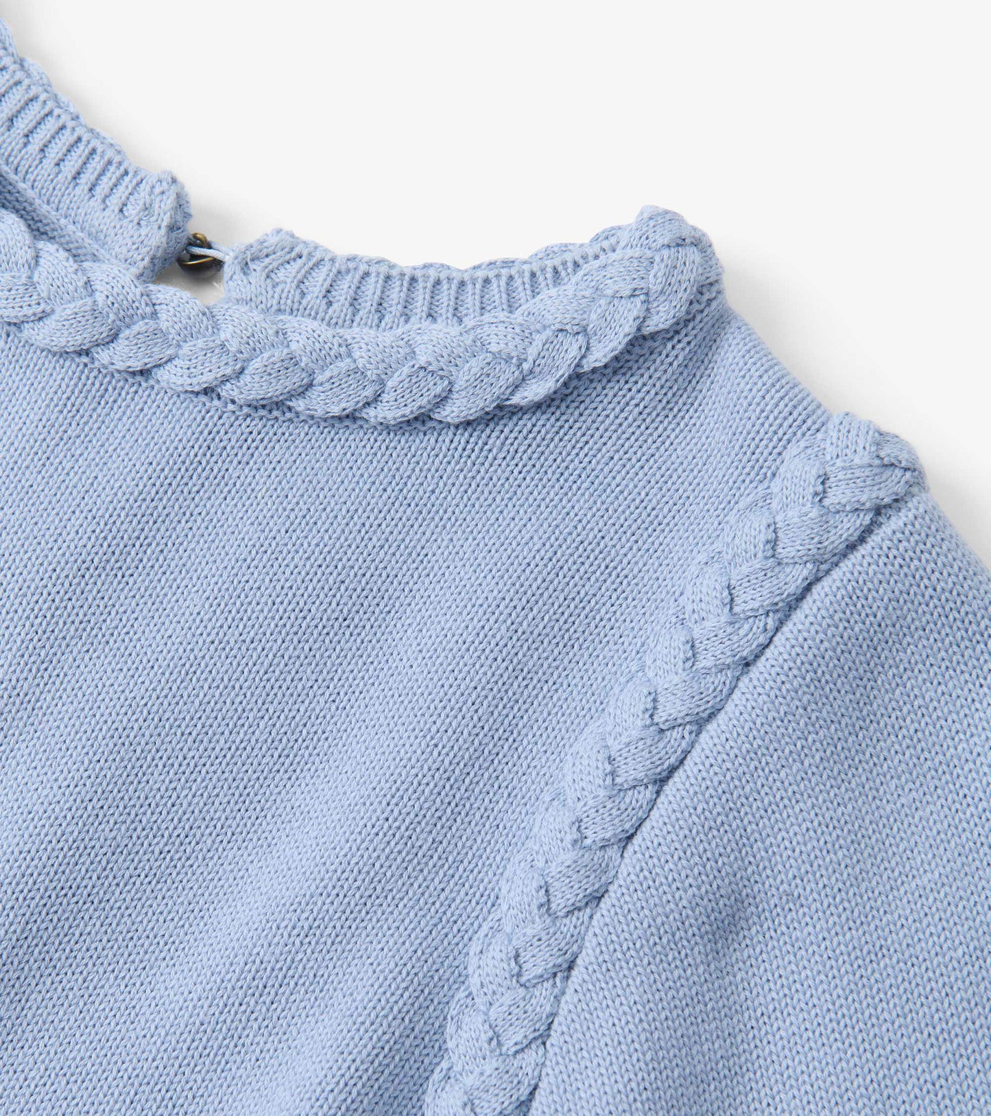 Light blue knit sweater with braided trim at the neckline and shoulder seam, close-up view