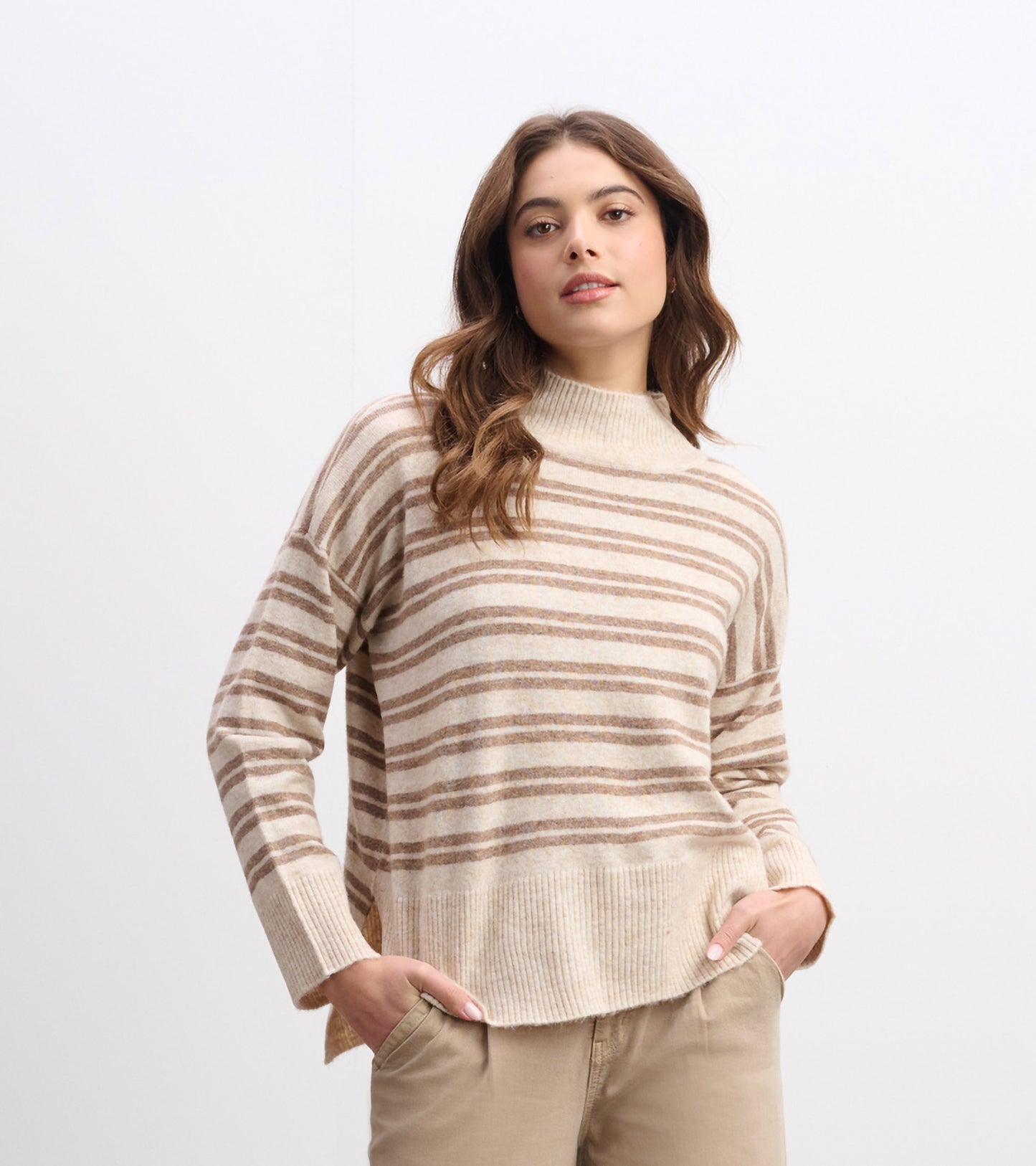 Cream and camel striped mock neck sweater with long sleeves and ribbed hem, worn by model front view