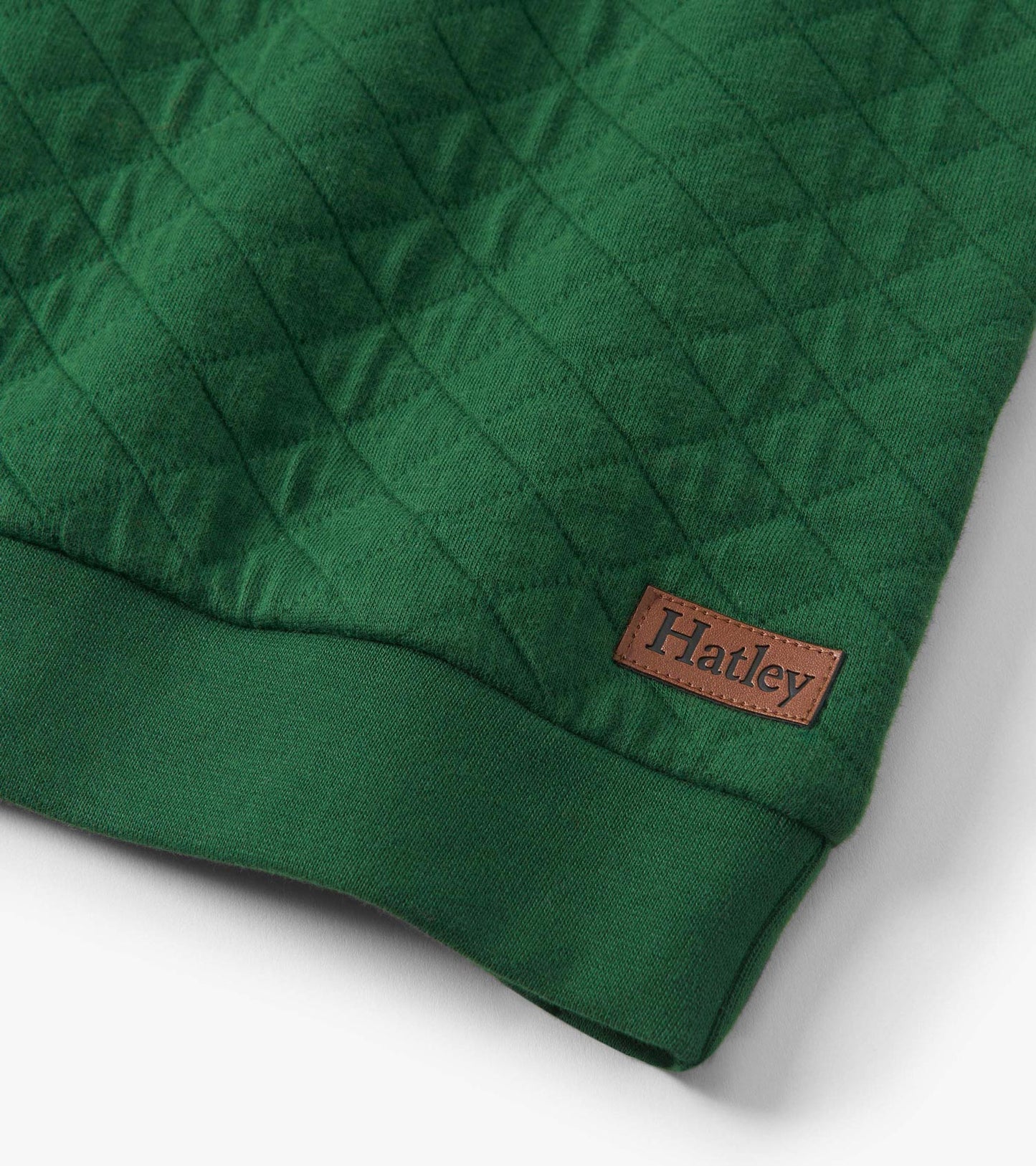 Green quilted pullover with a textured pattern and ribbed hem, featuring a small leather tag.