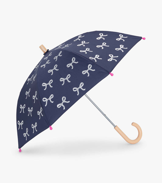 Navy umbrella with silver ribbon patterns and pink tips, featuring a curved wooden handle.
