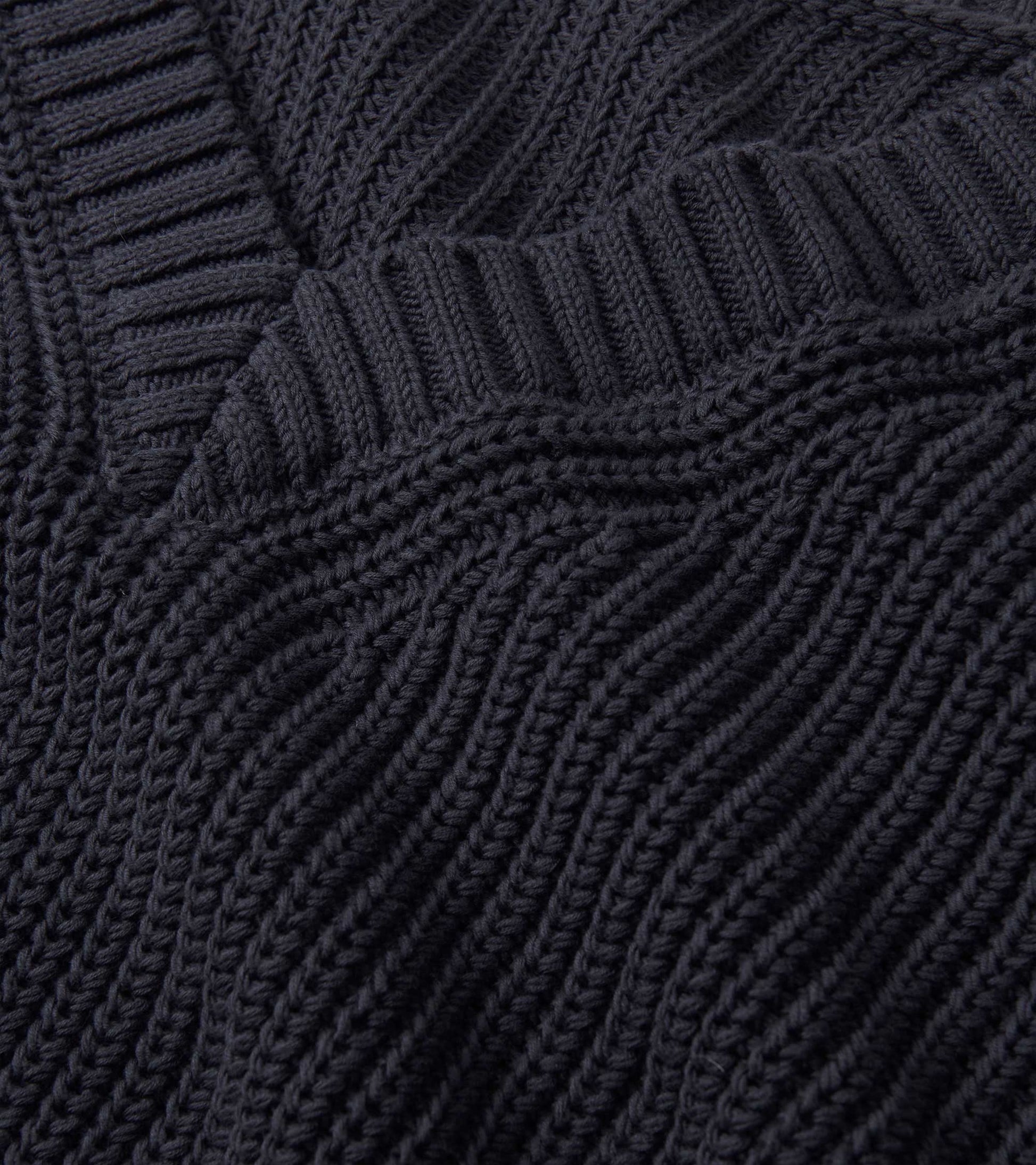 Faded grey V-neck slouchy sweater with textured ribbed knit pattern, showcasing a relaxed fit and soft fabric.
