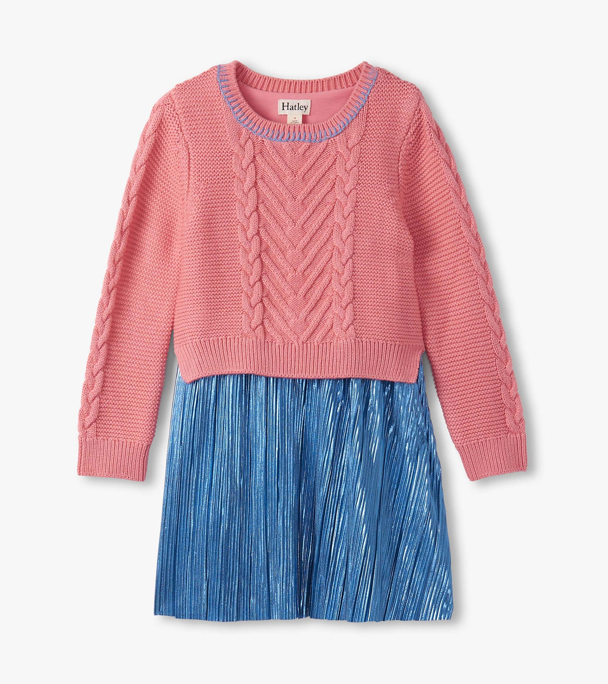 Flamingo pink knit top with cable pattern and blue pleated skirt, ideal for casual wear.