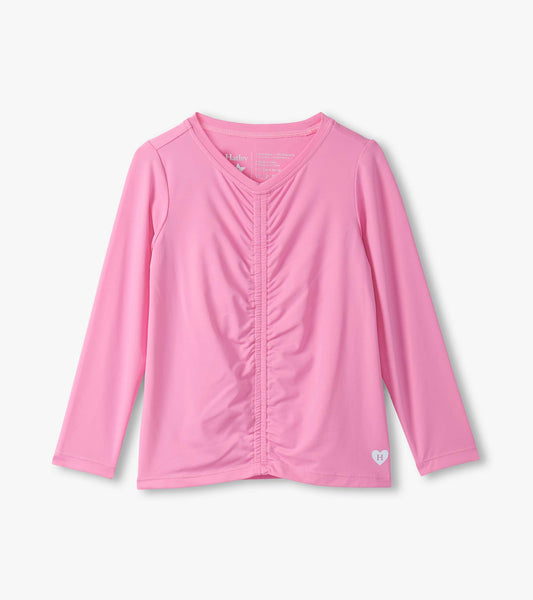 Fuchsia pink long-sleeve top with gathered front detail and a rounded neckline.