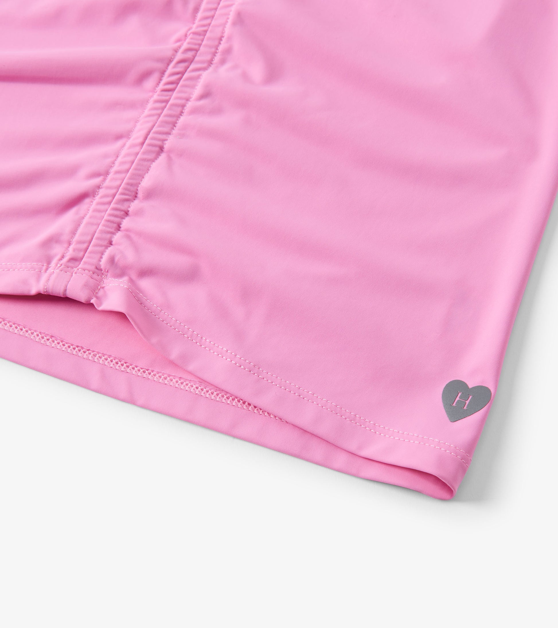 Fuchsia pink gathered front top with a heart logo detail, made from soft fabric, suitable for casual wear.