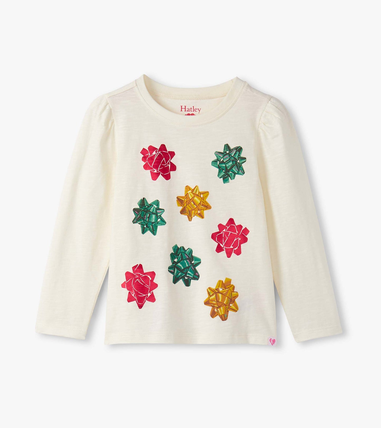 Cream long-sleeve tee featuring colorful bow graphics in red, green, and gold on the front. Puff sleeves add a playful touch.