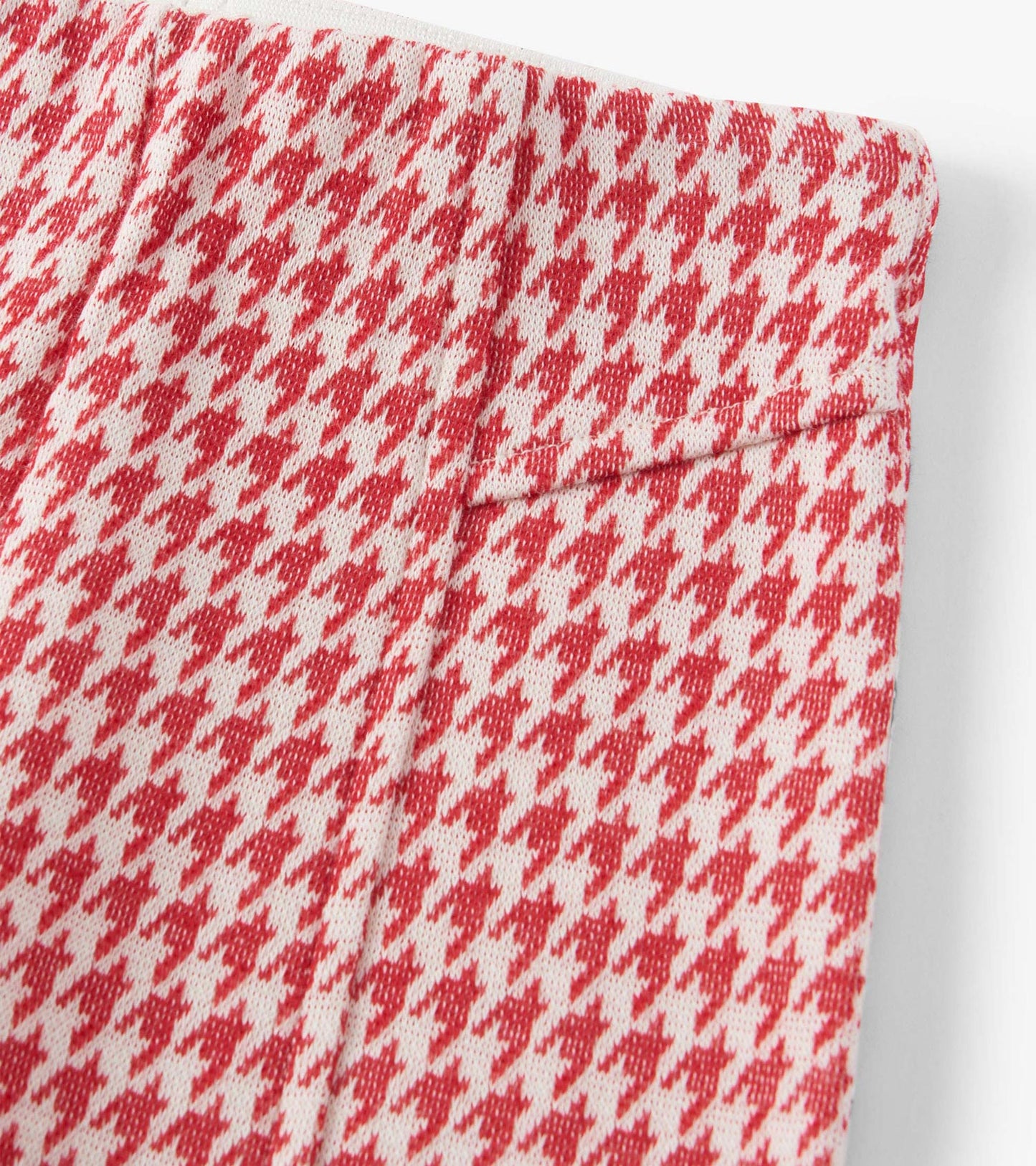 Red houndstooth patterned bell bottom pants with a soft fabric and elastic waistband.